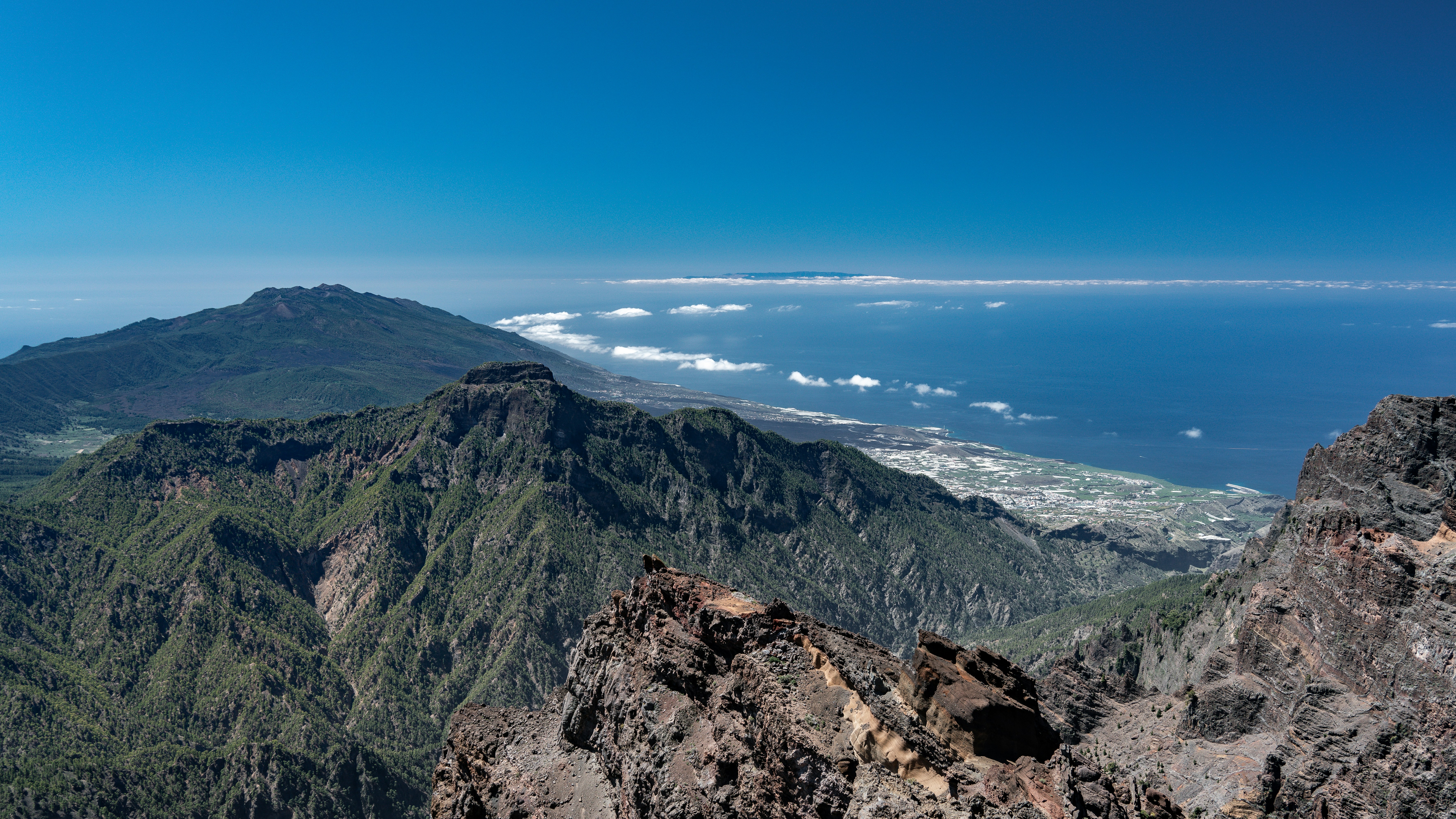 the view from the top of a mountain overlooking the ocean