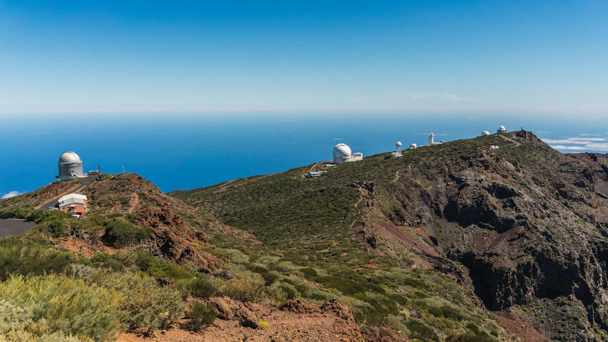 Observatory domes along the green crest of Roque de los Muchachos, with the ocean far below