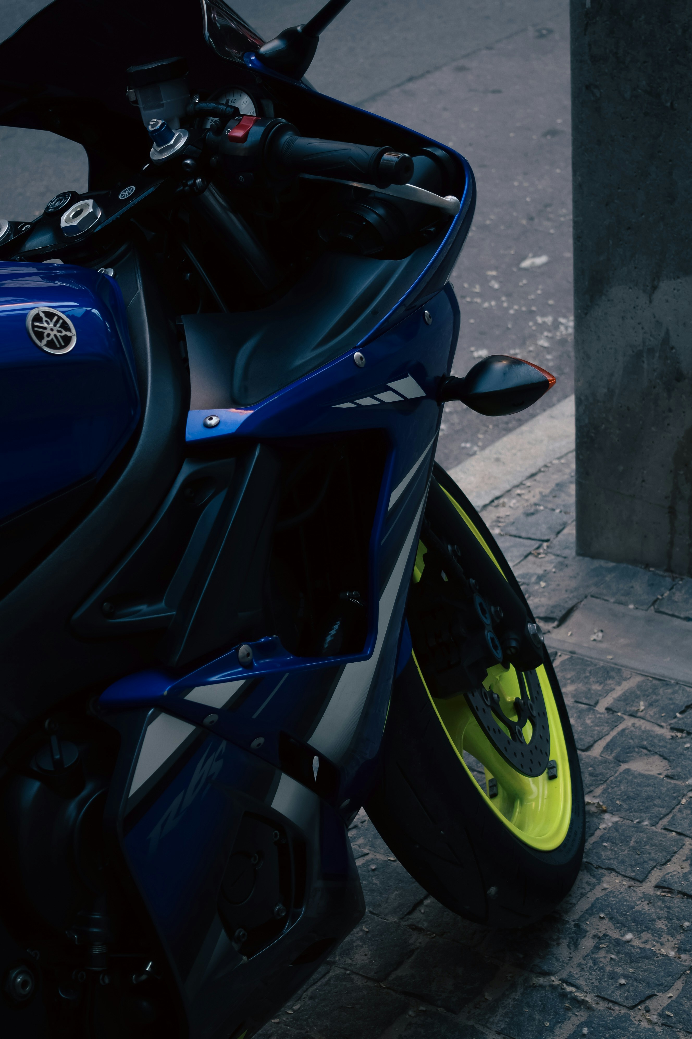 a blue motorcycle parked on the side of the road