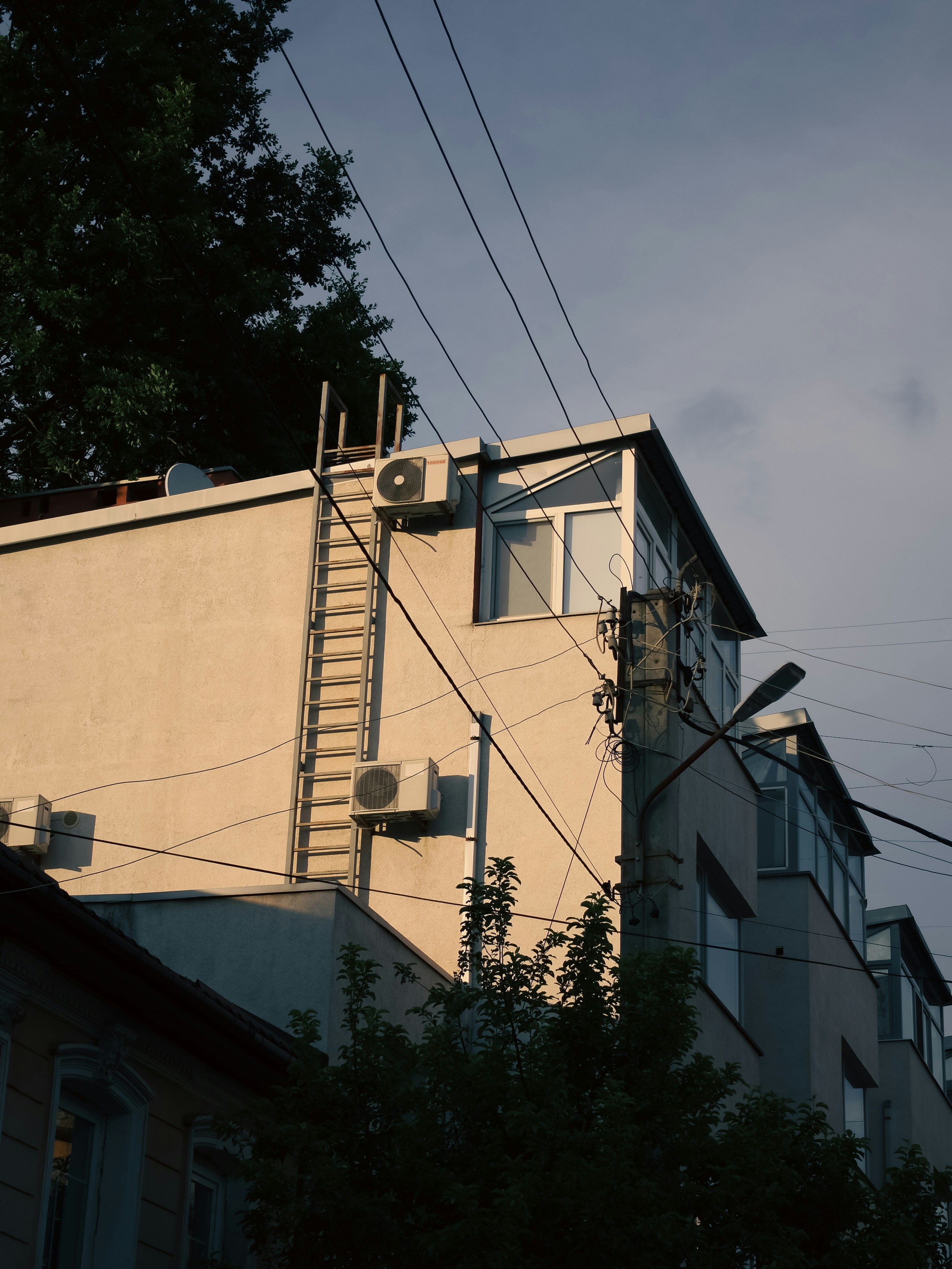 a tall building with a ladder on the side of it
