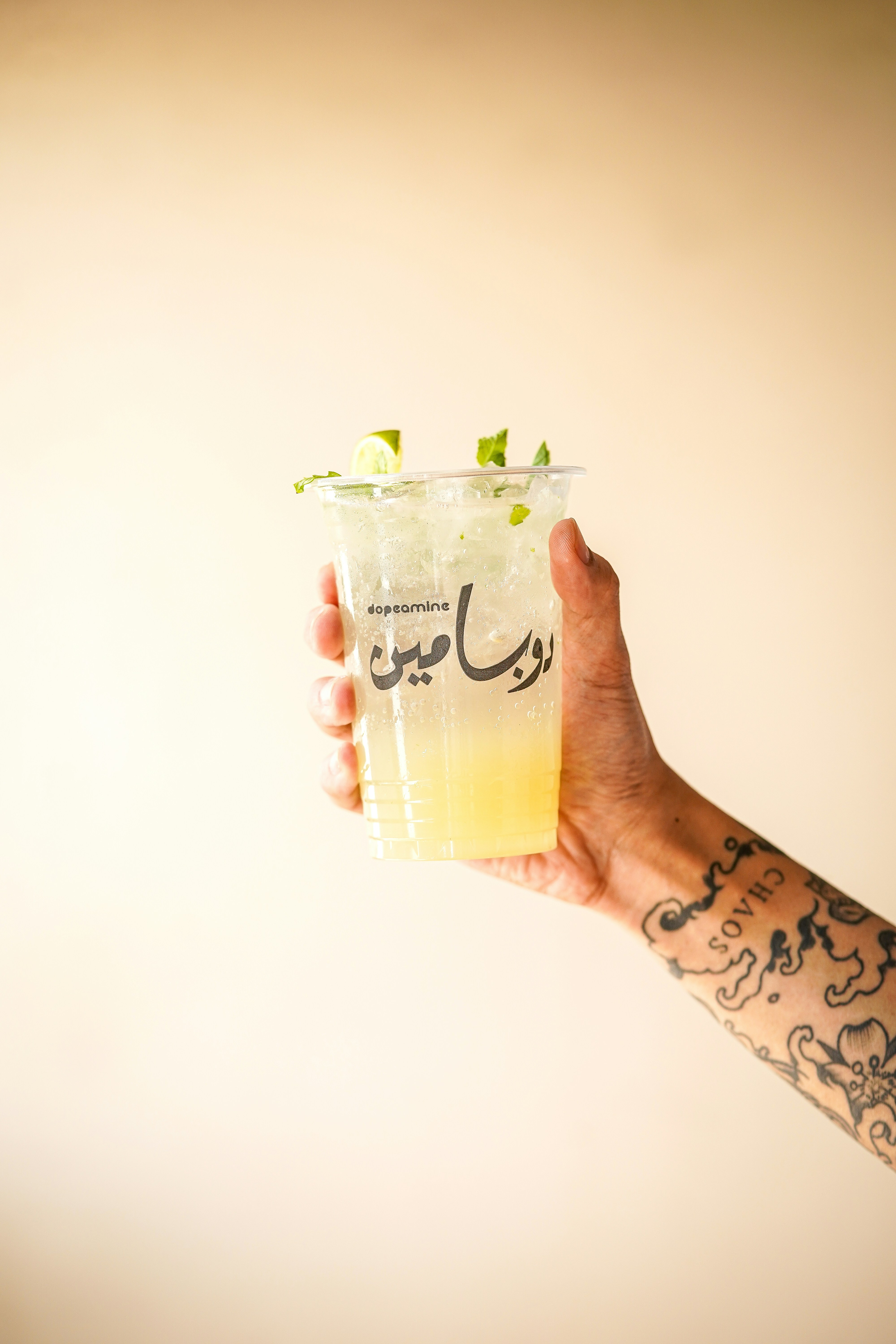 a person holding a drink in their hand