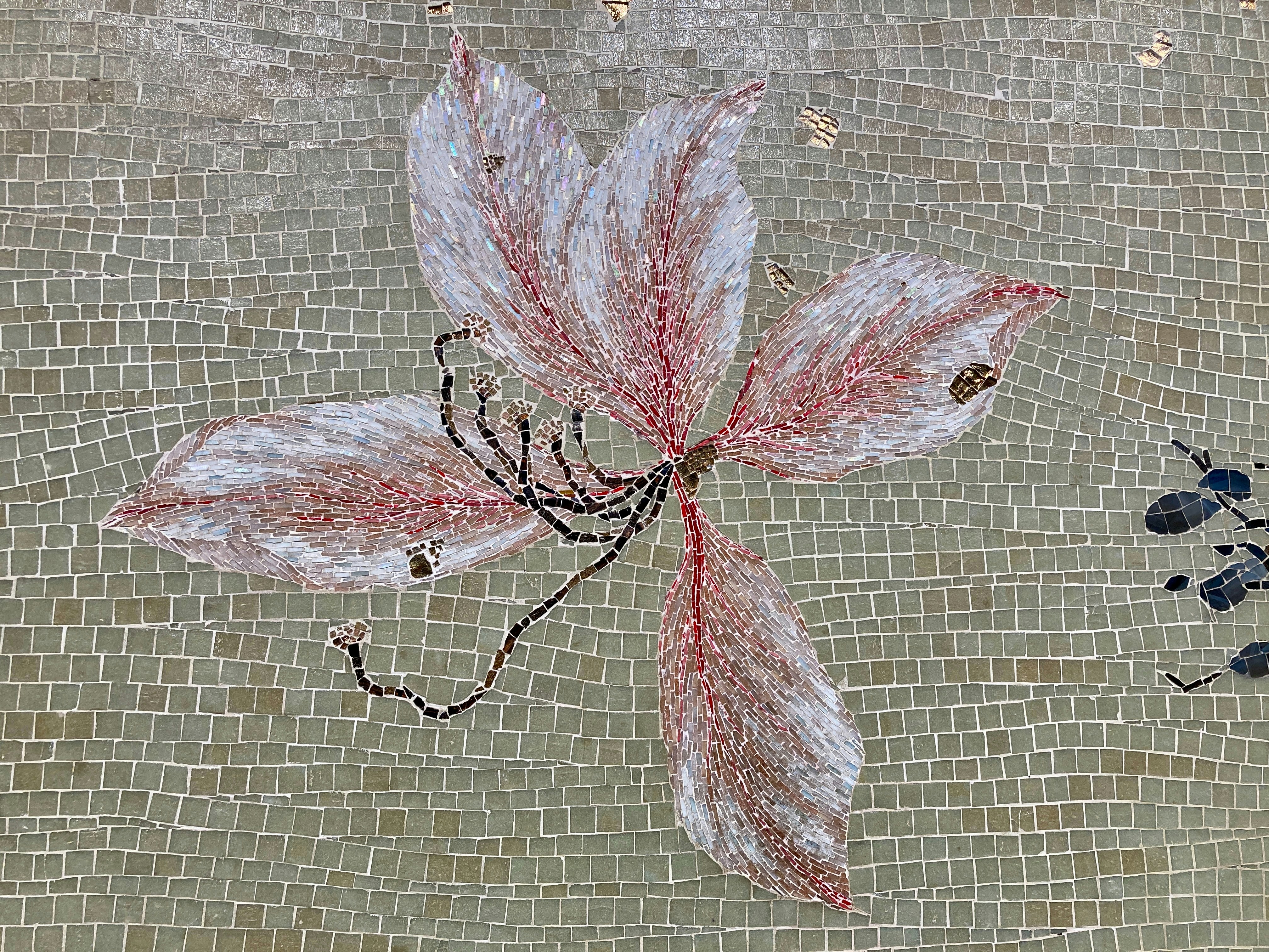 a painting of a flower on a tile wall