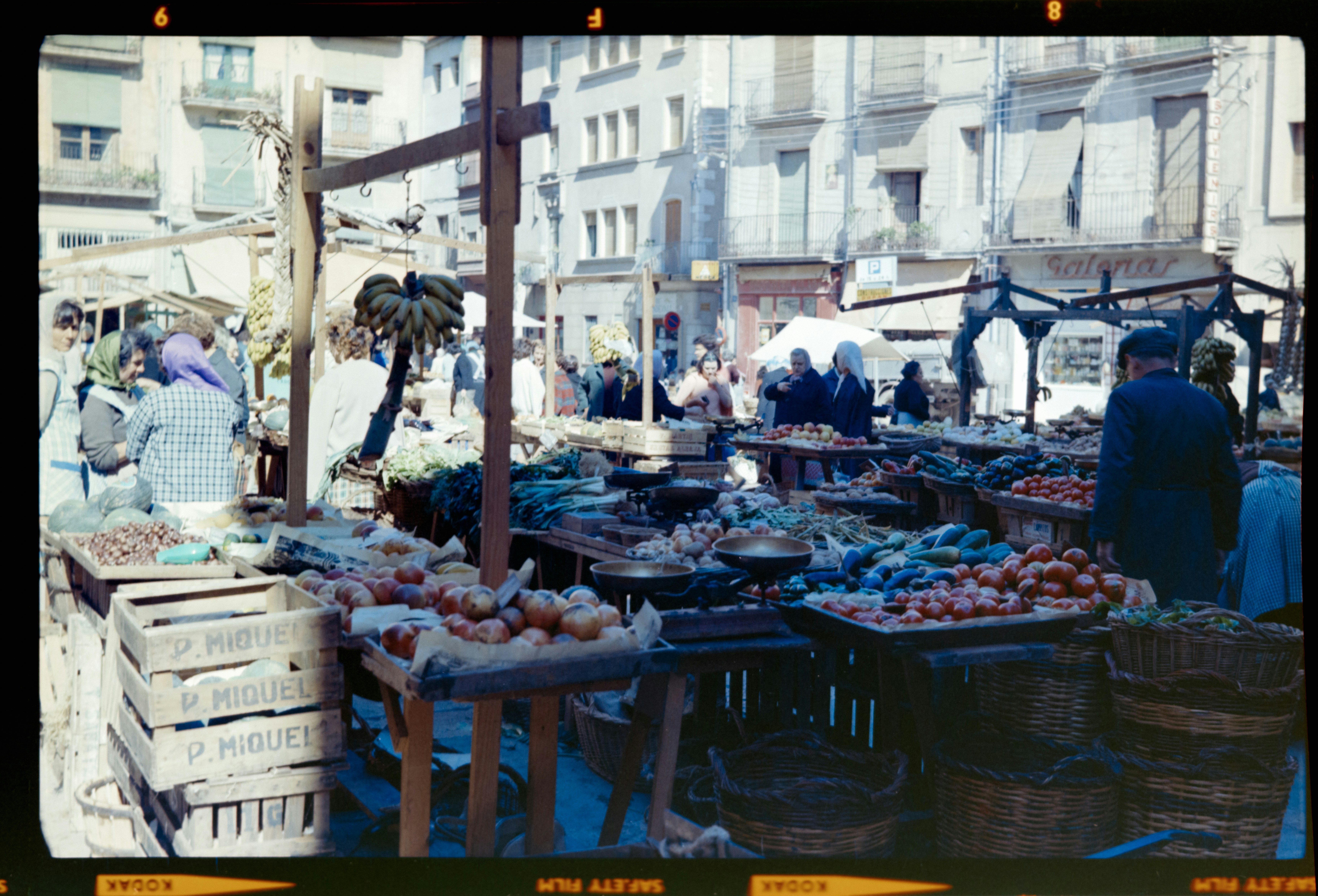 an old photo of a farmers market with people shopping