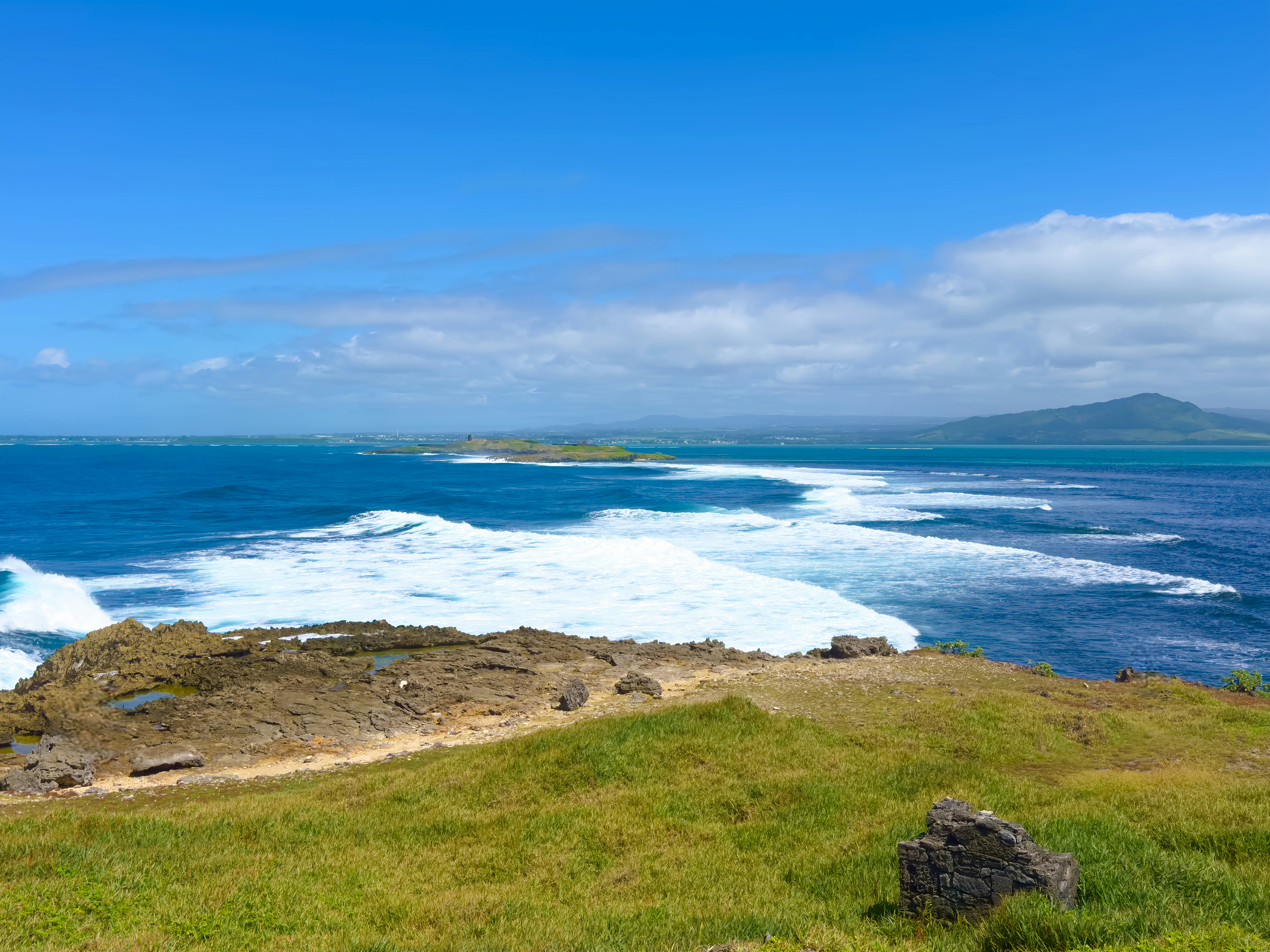 a view of the ocean from the top of a hill, 
