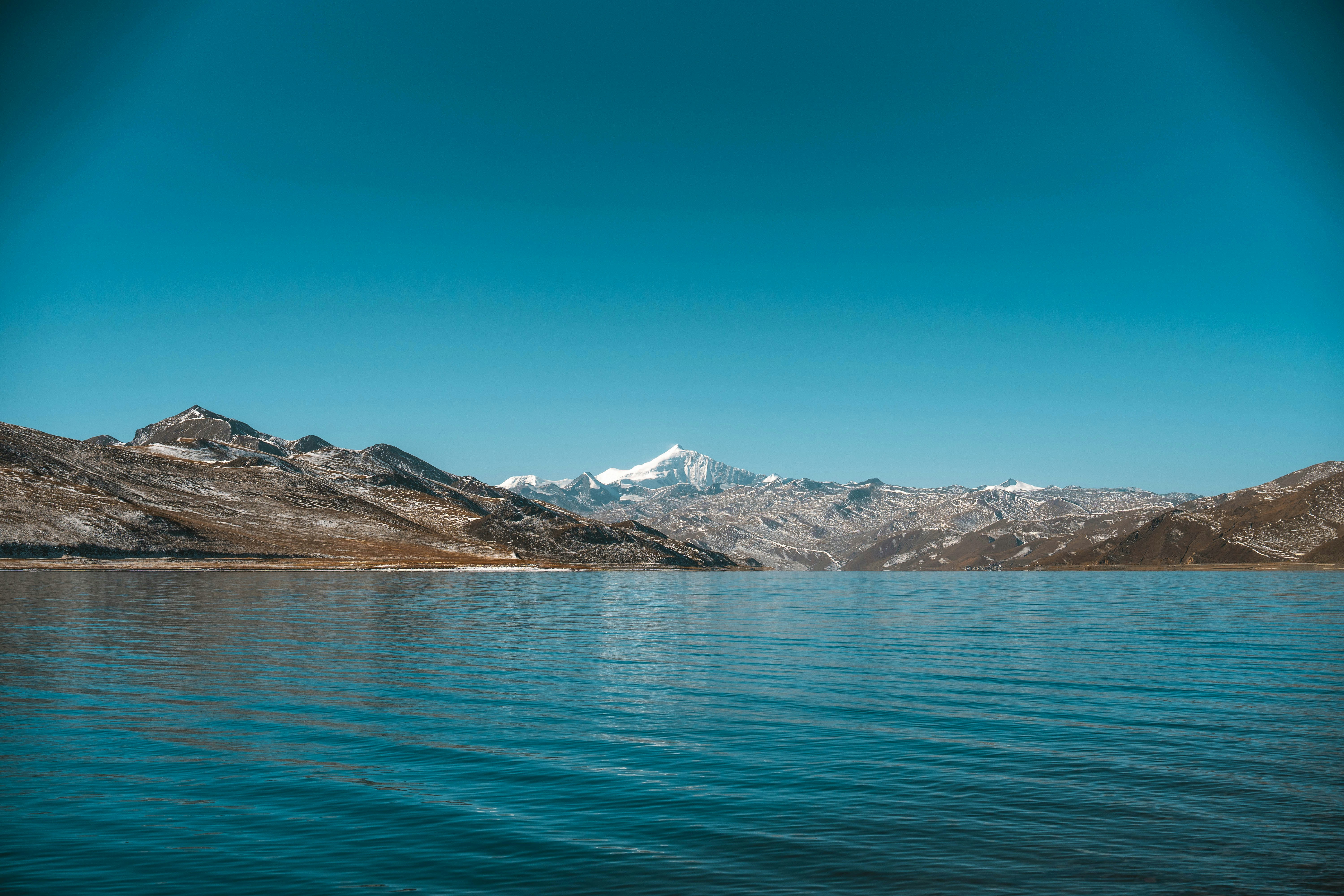a large body of water with mountains in the background, Mount Everest