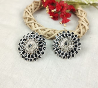 a pair of earrings sitting on top of a table