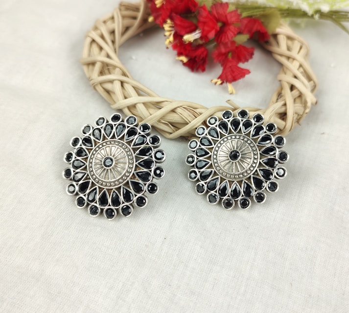a pair of earrings sitting on top of a table