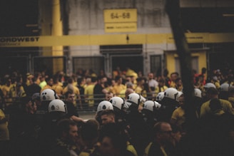 a large group of people wearing helmets in front of a building