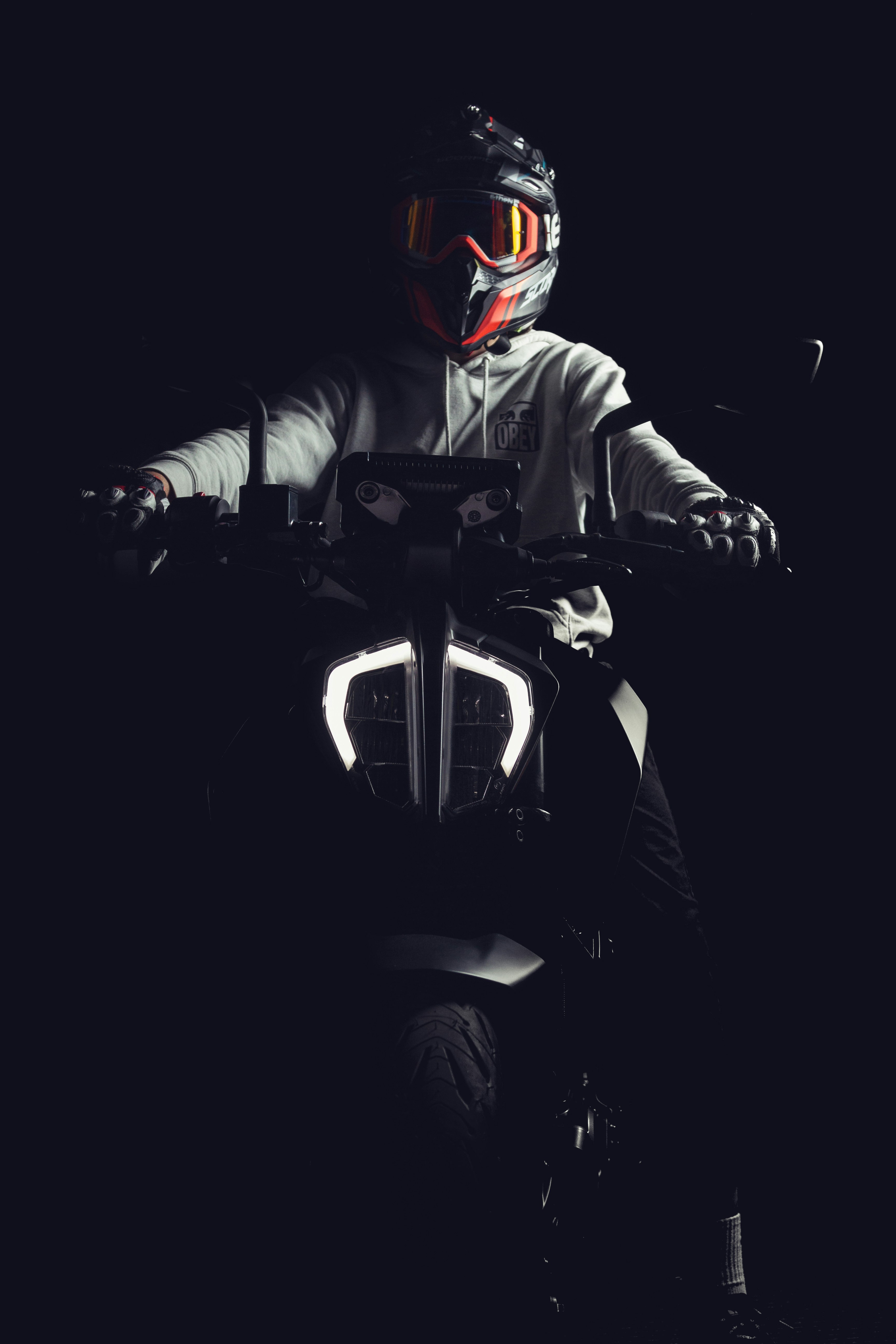 a man riding a motorcycle in the dark