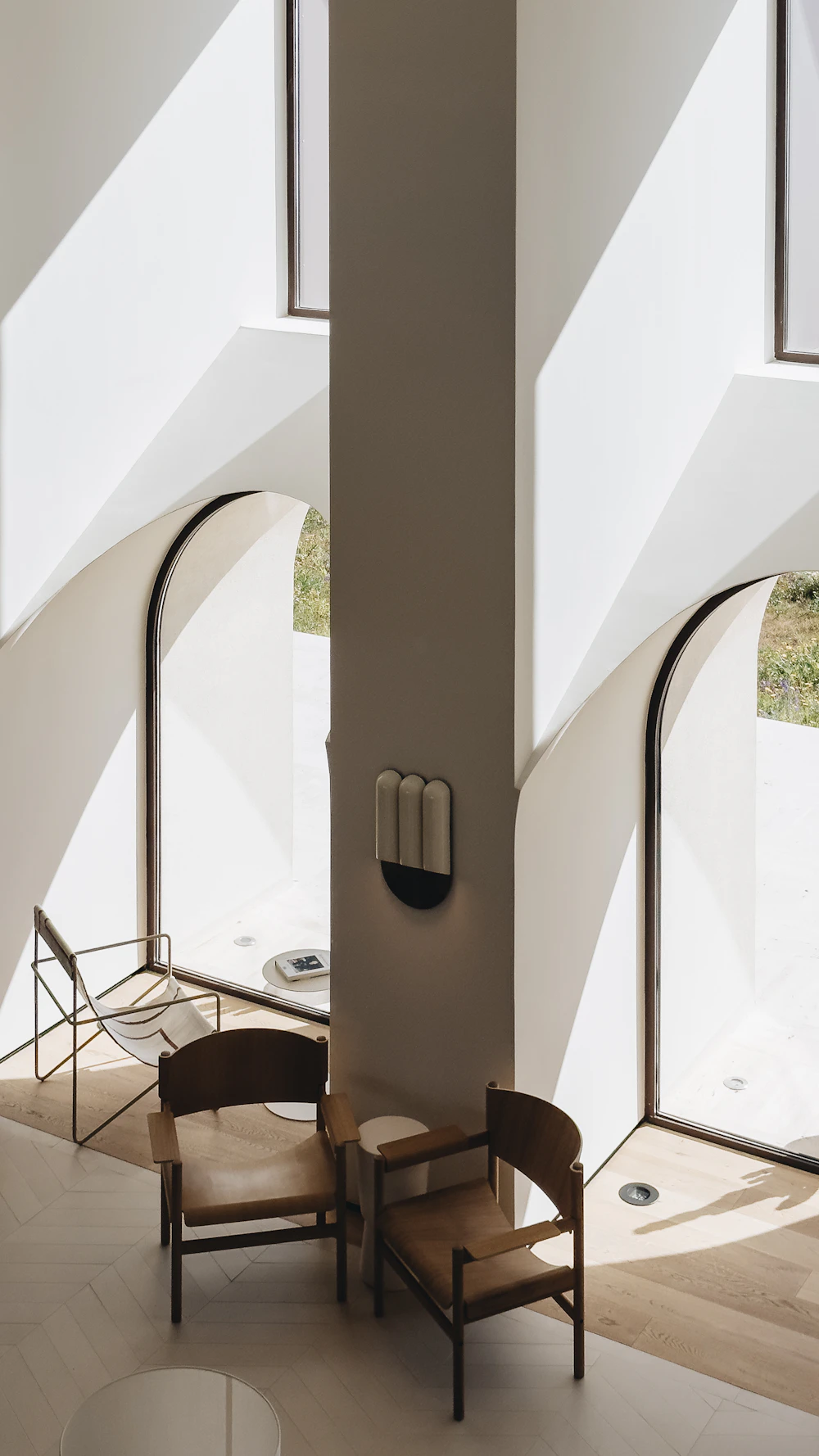 Soft daylight through white arched openings