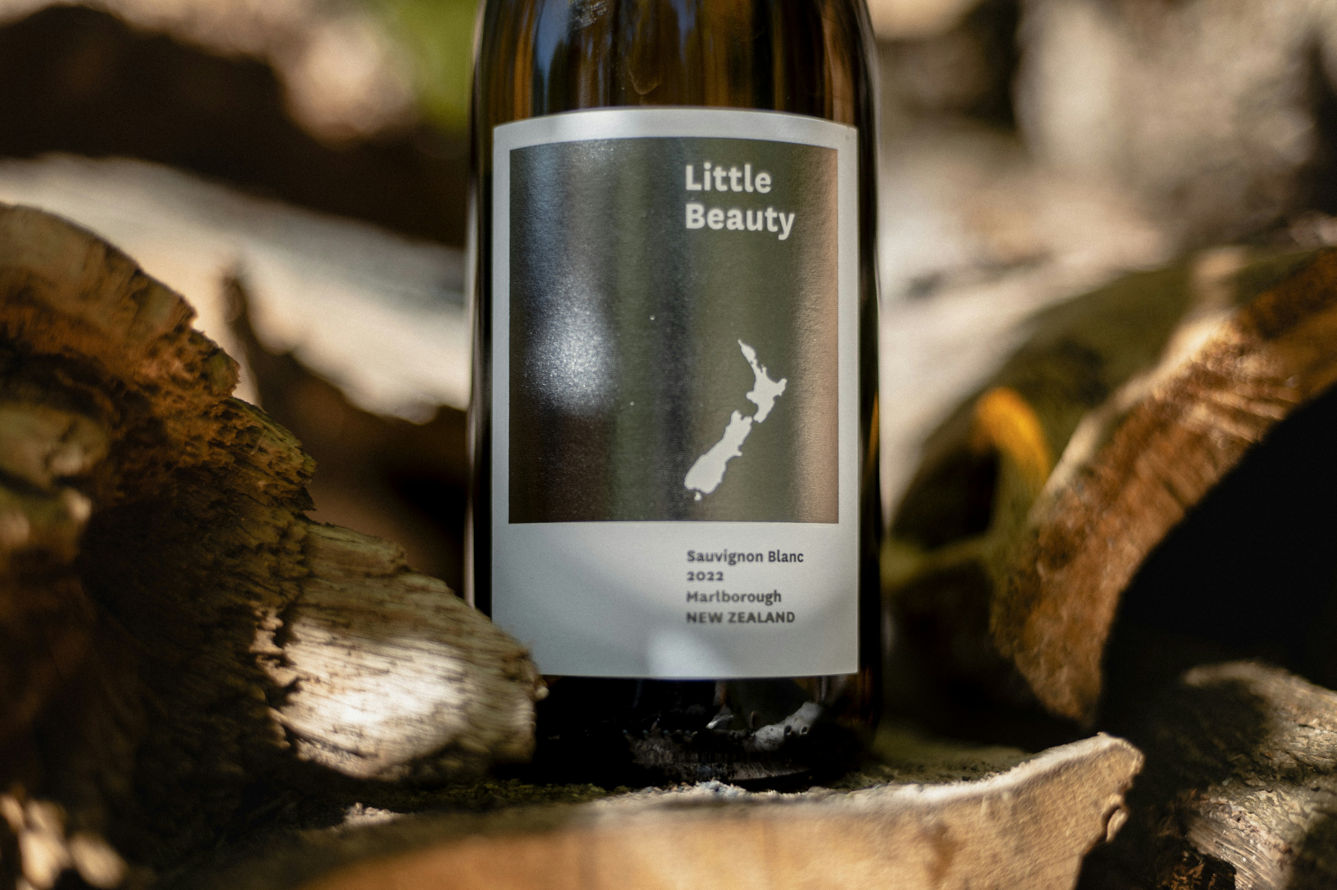 White wine bottle in sunlight on natural background.