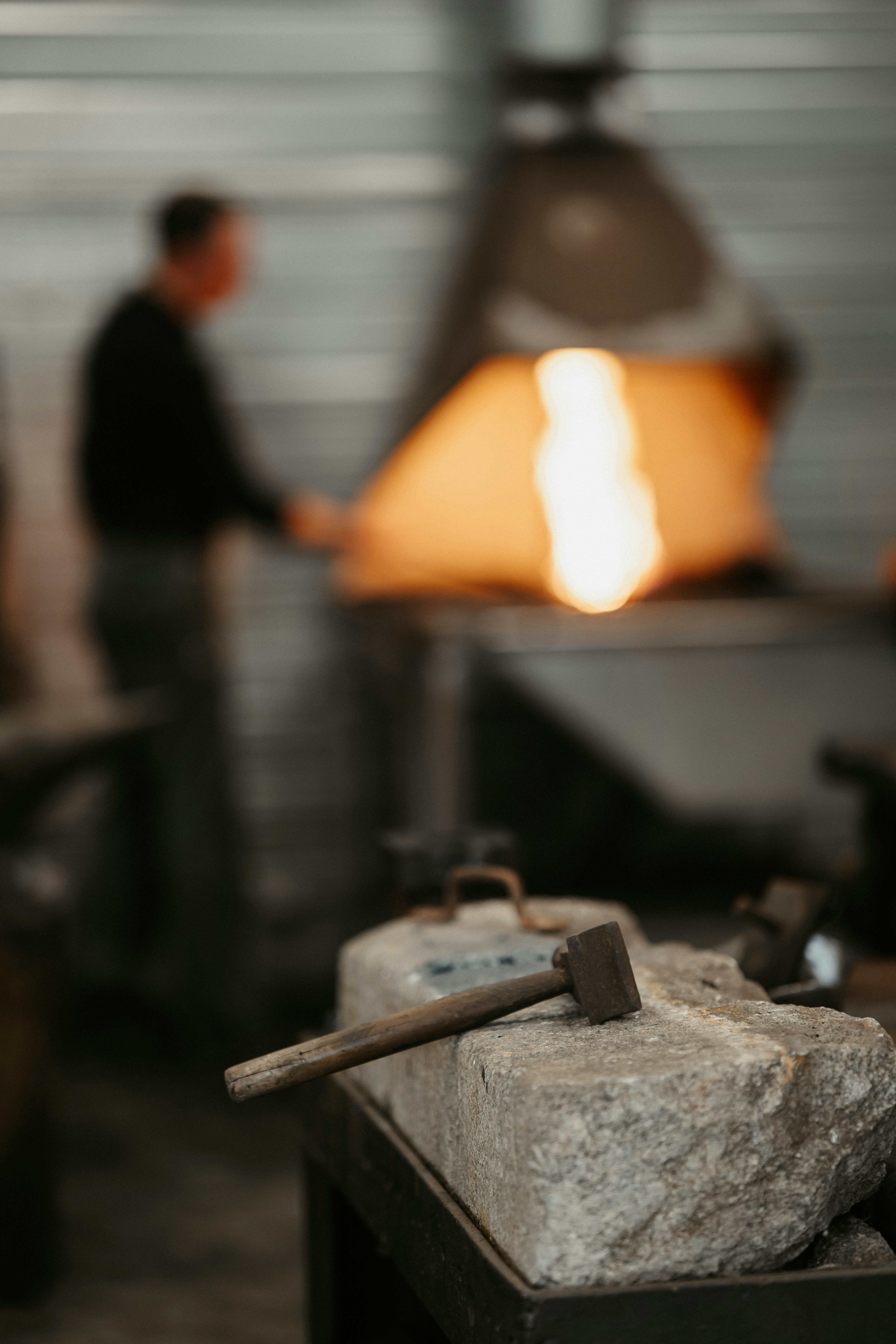 a man standing in front of a metal furnace
