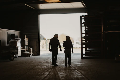 a man and a woman walking into a garage