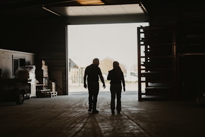 a man and a woman walking into a garage