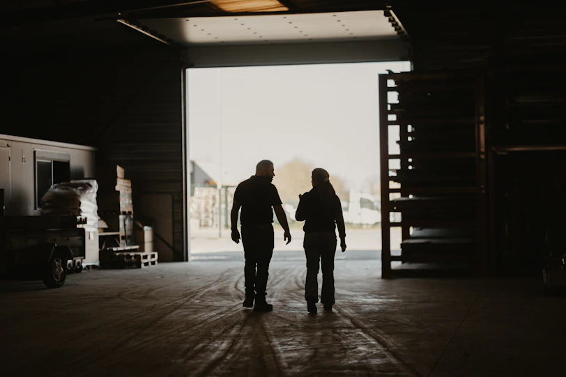 a man and a woman walking into a garage