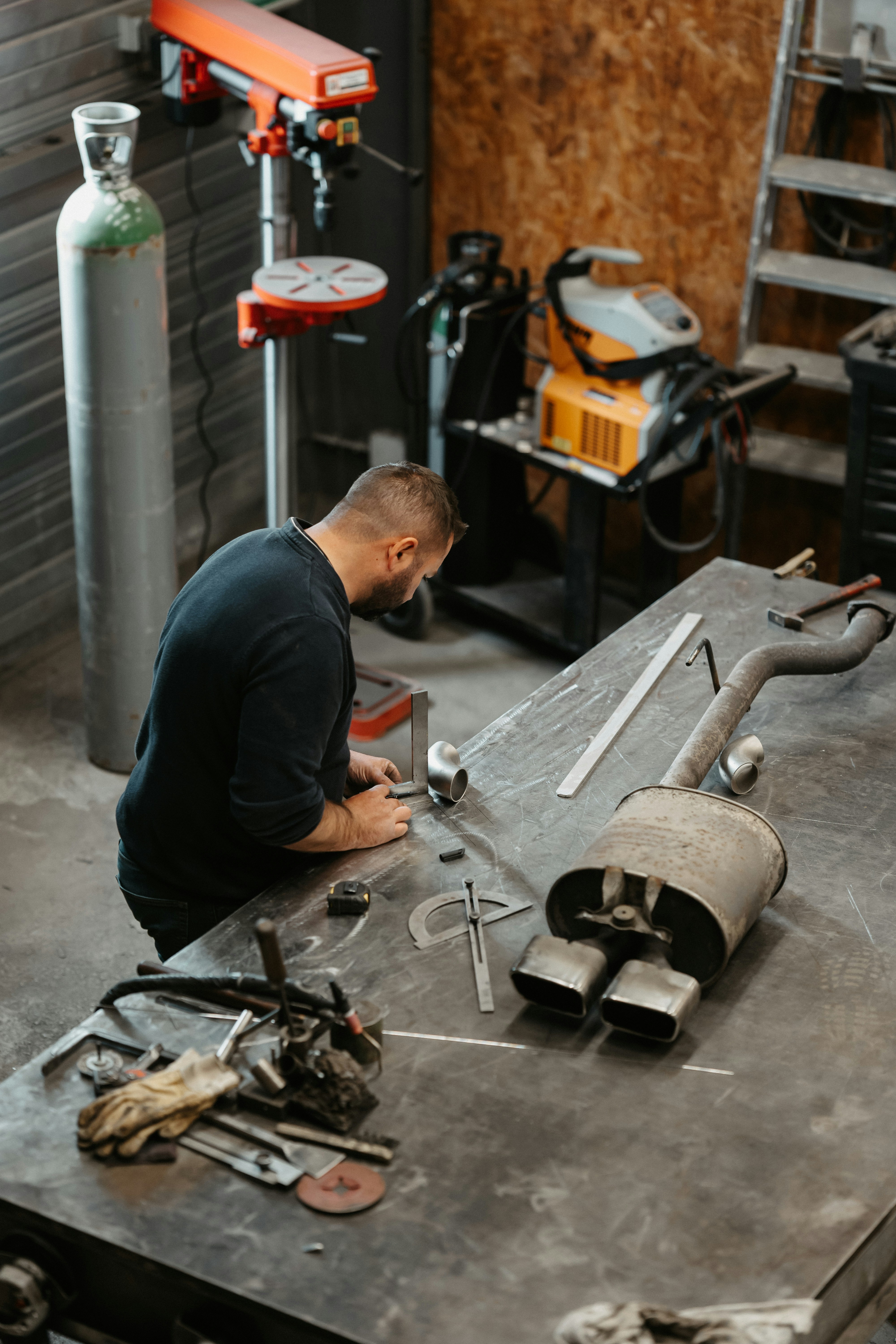 a man working on a machine in a garage