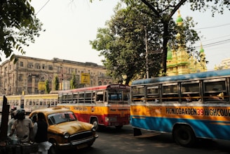a couple of buses that are sitting in the street