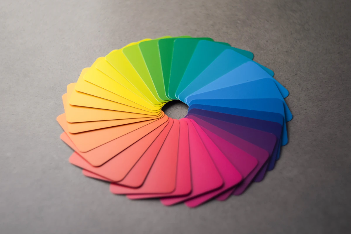 A circular arrangement of different colored swatches on a table, representing the many possible color differences a spectrophotometer can measure