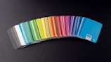 a stack of rainbow colored cards sitting on top of a table