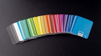 a stack of rainbow colored cards sitting on top of a table