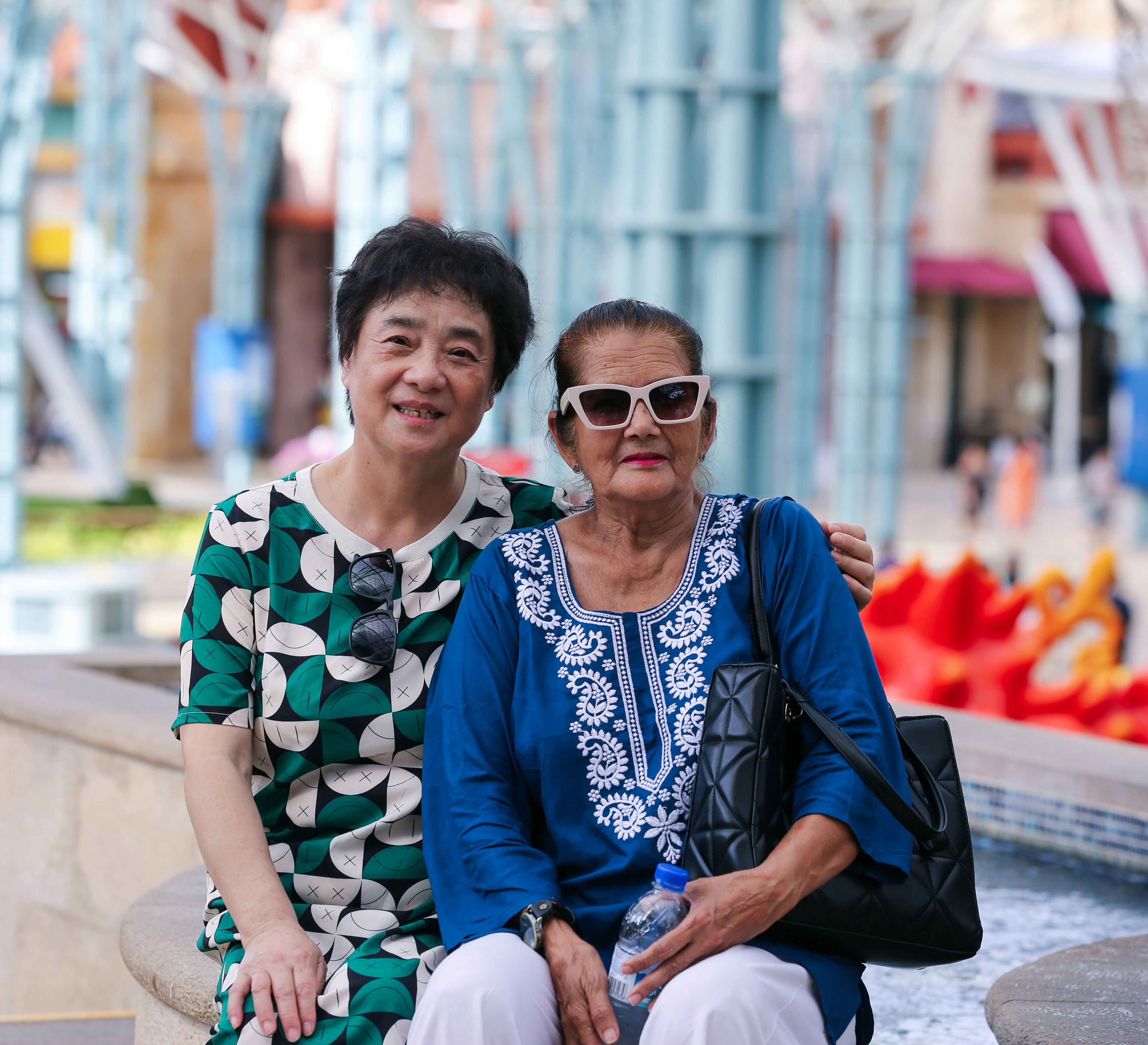 an older woman sitting next to a younger woman