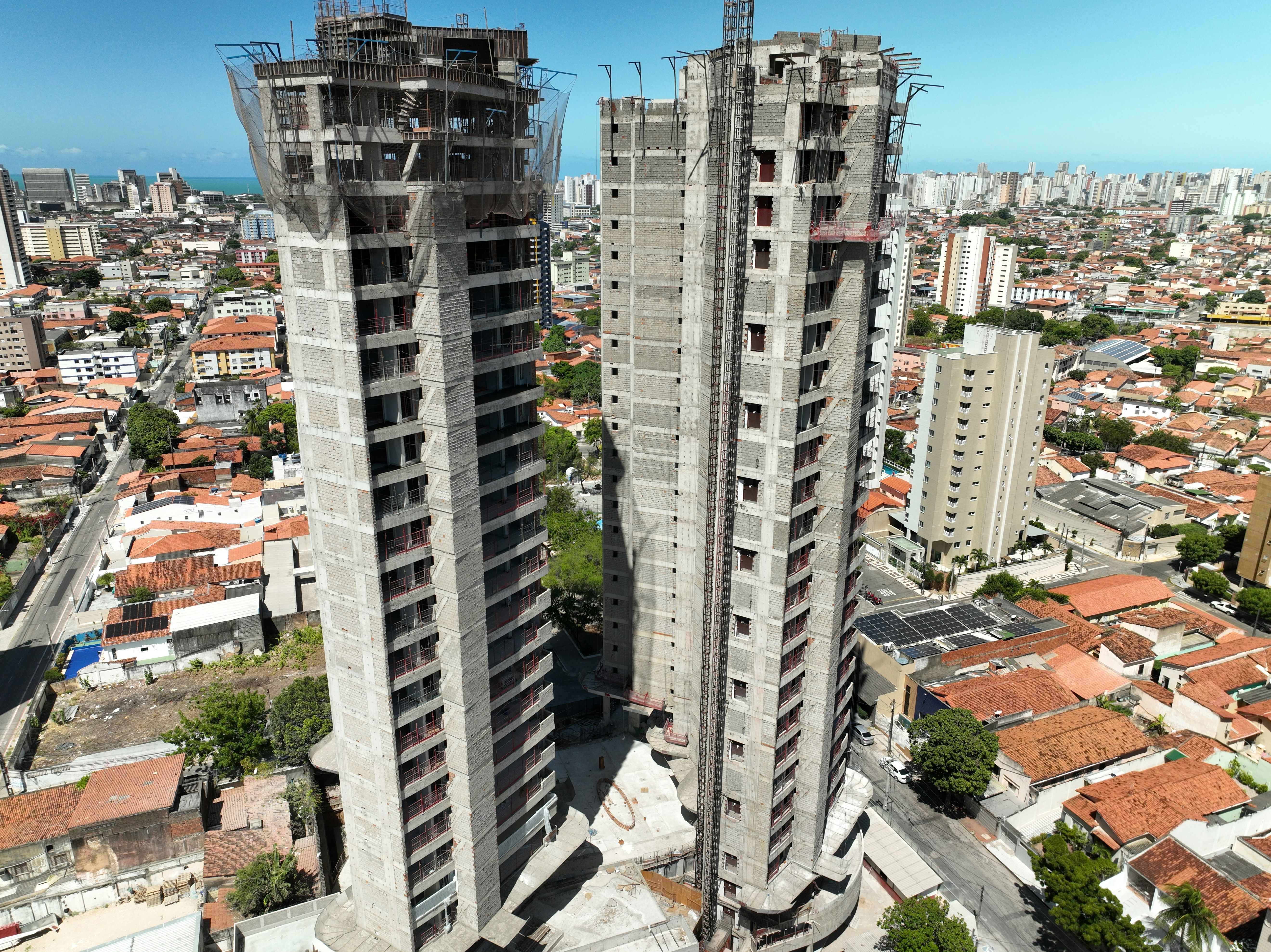 an aerial view of two tall buildings in a city