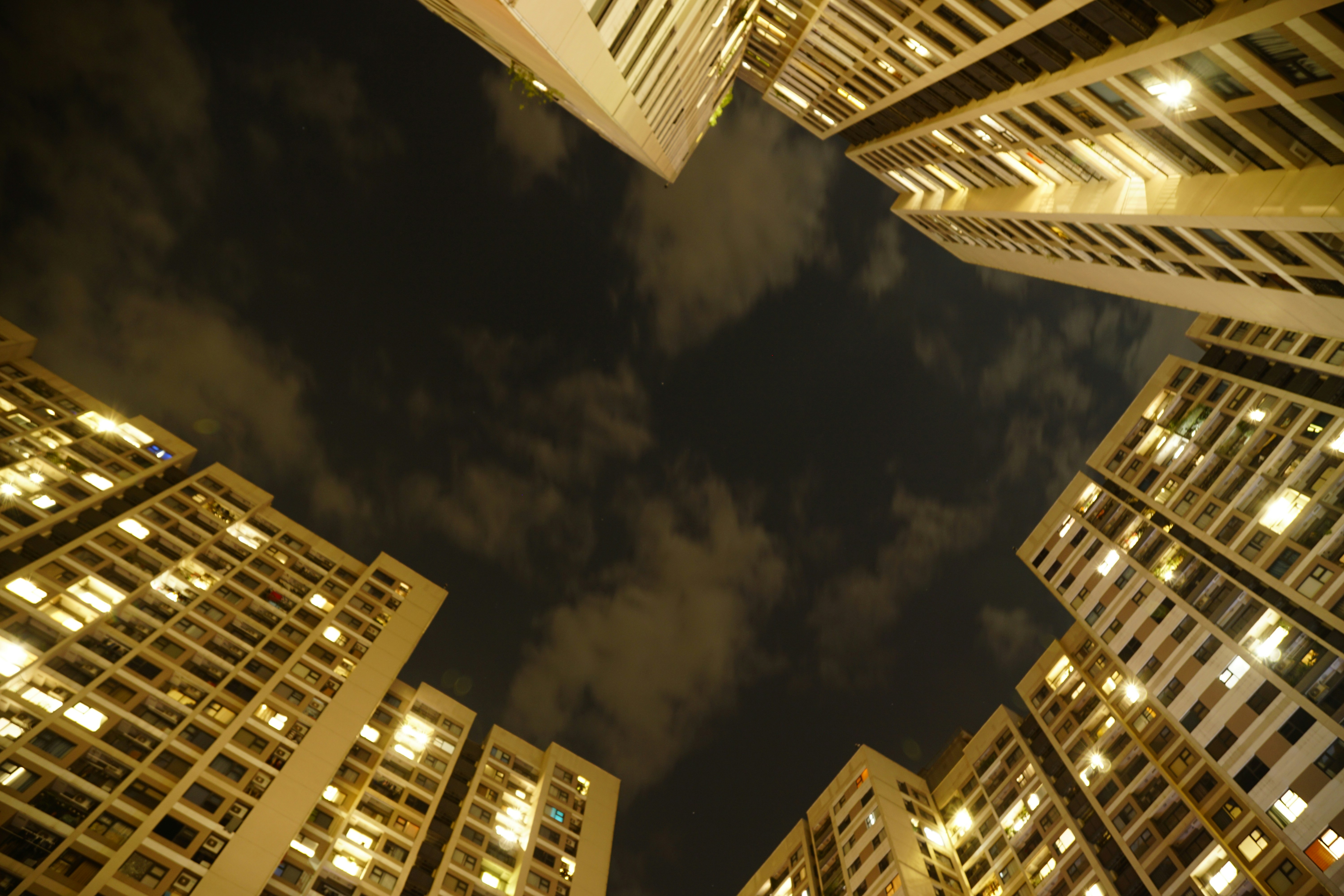 A group of tall buildings in a city at night