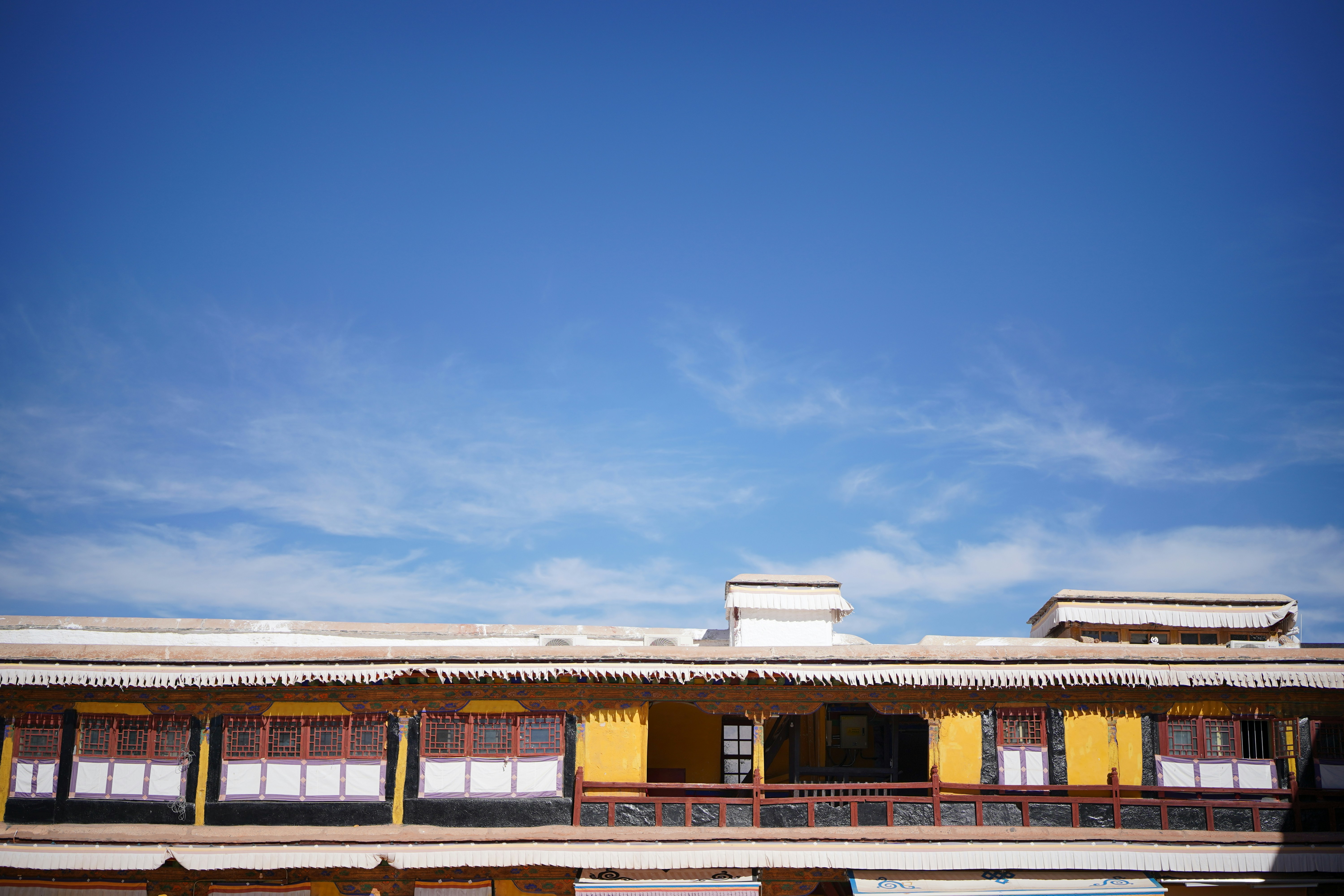 a yellow building with a blue sky in the background