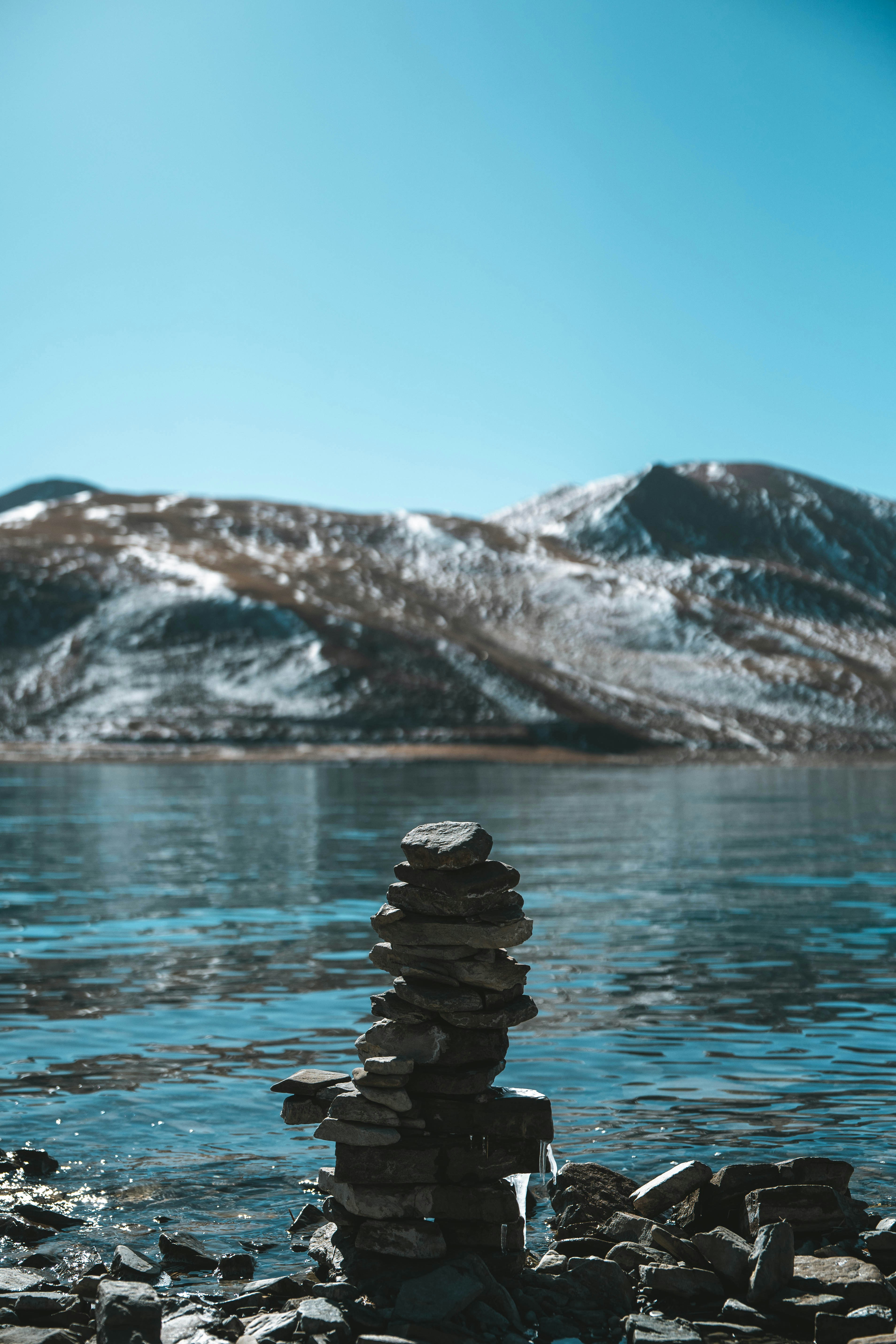 a stack of rocks sitting on top of a lake