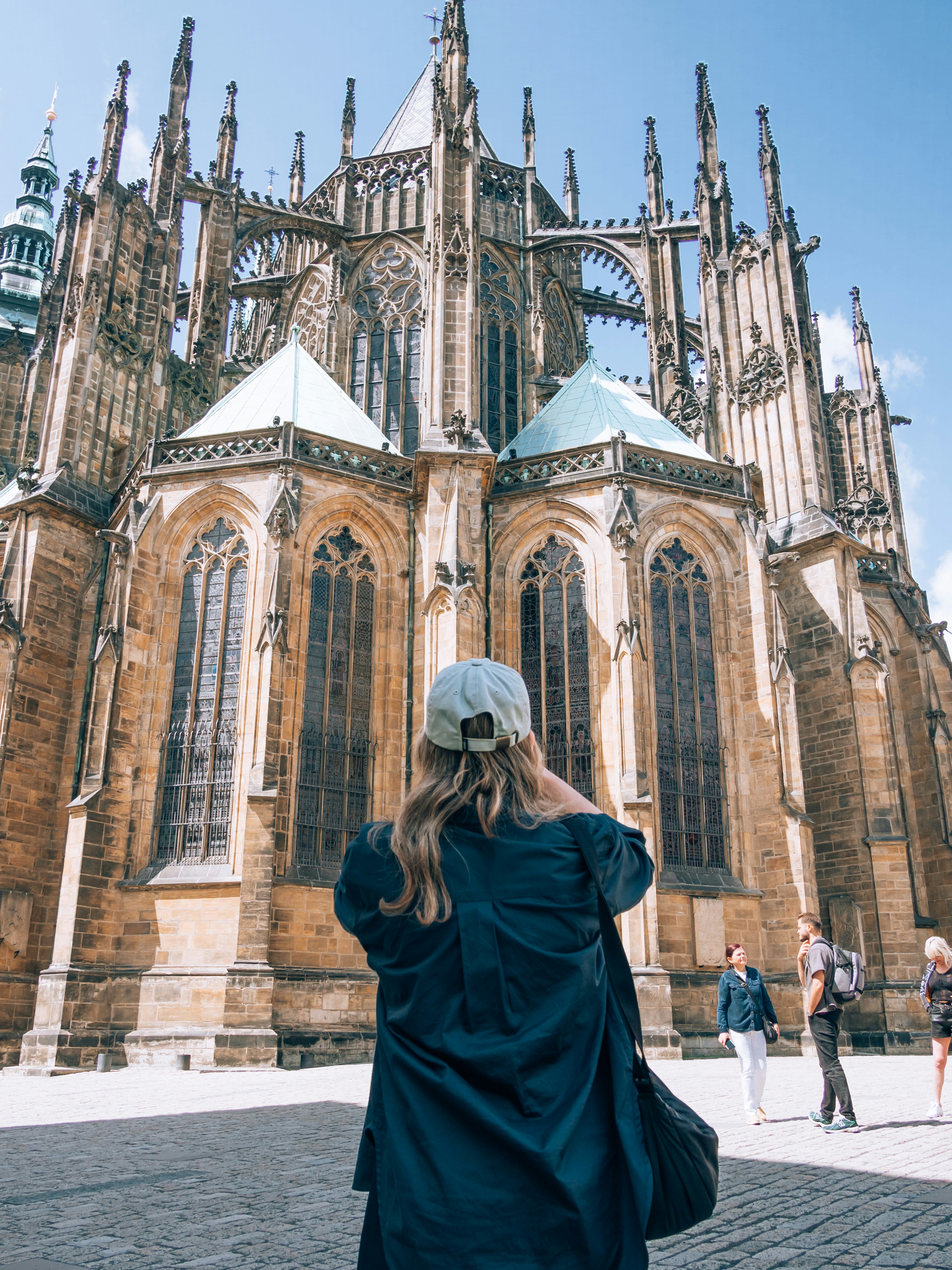 a woman standing in front of a large cathedral