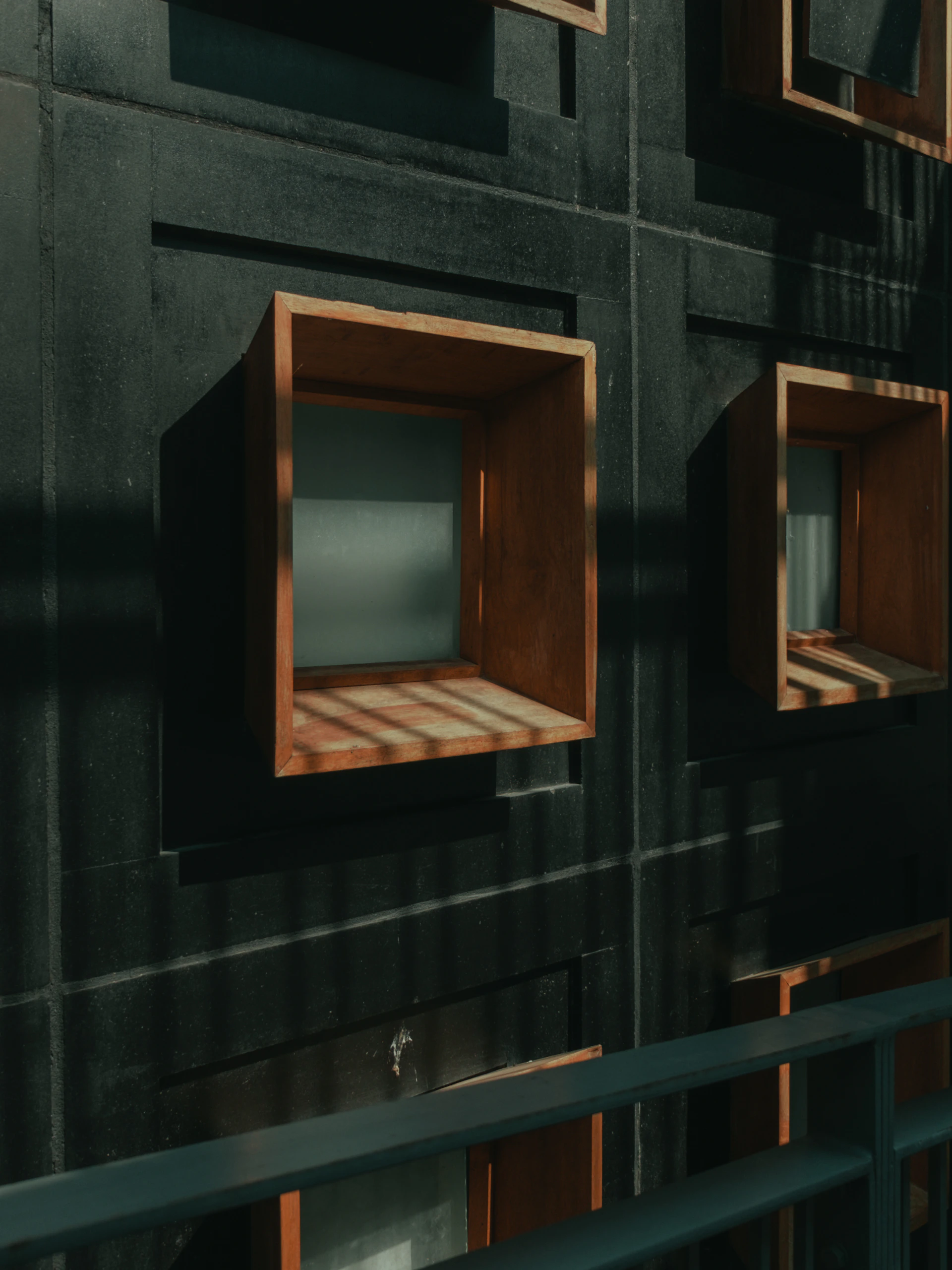 a group of wooden boxes mounted to a wall