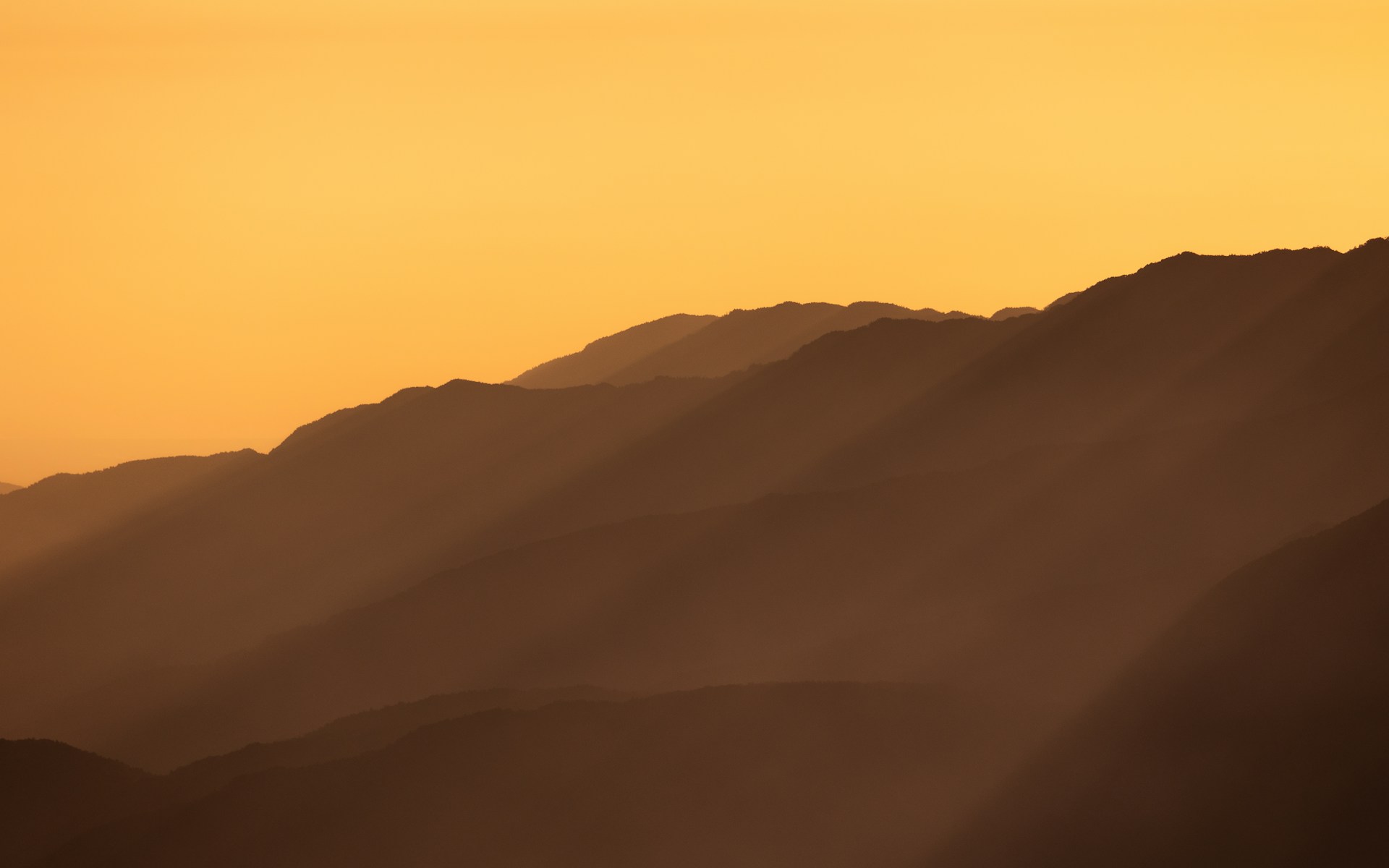 a view of a mountain range at sunset