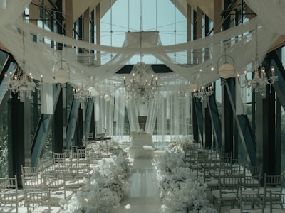 a wedding setup with white flowers and chandeliers