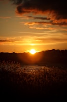 the sun is setting over a body of water