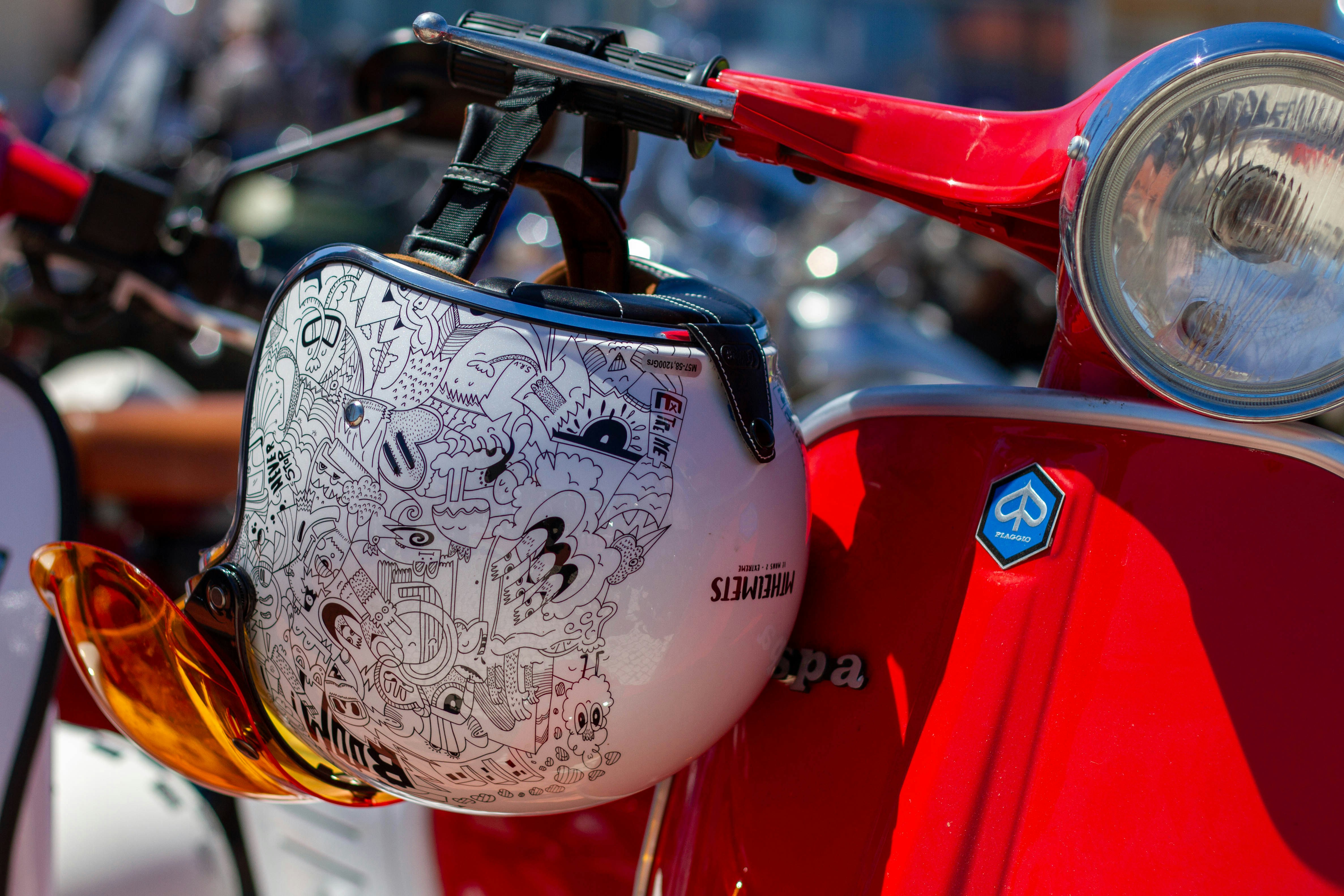 a close up of a red scooter with a helmet on it