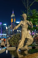 a statue of a man is in the middle of a fountain