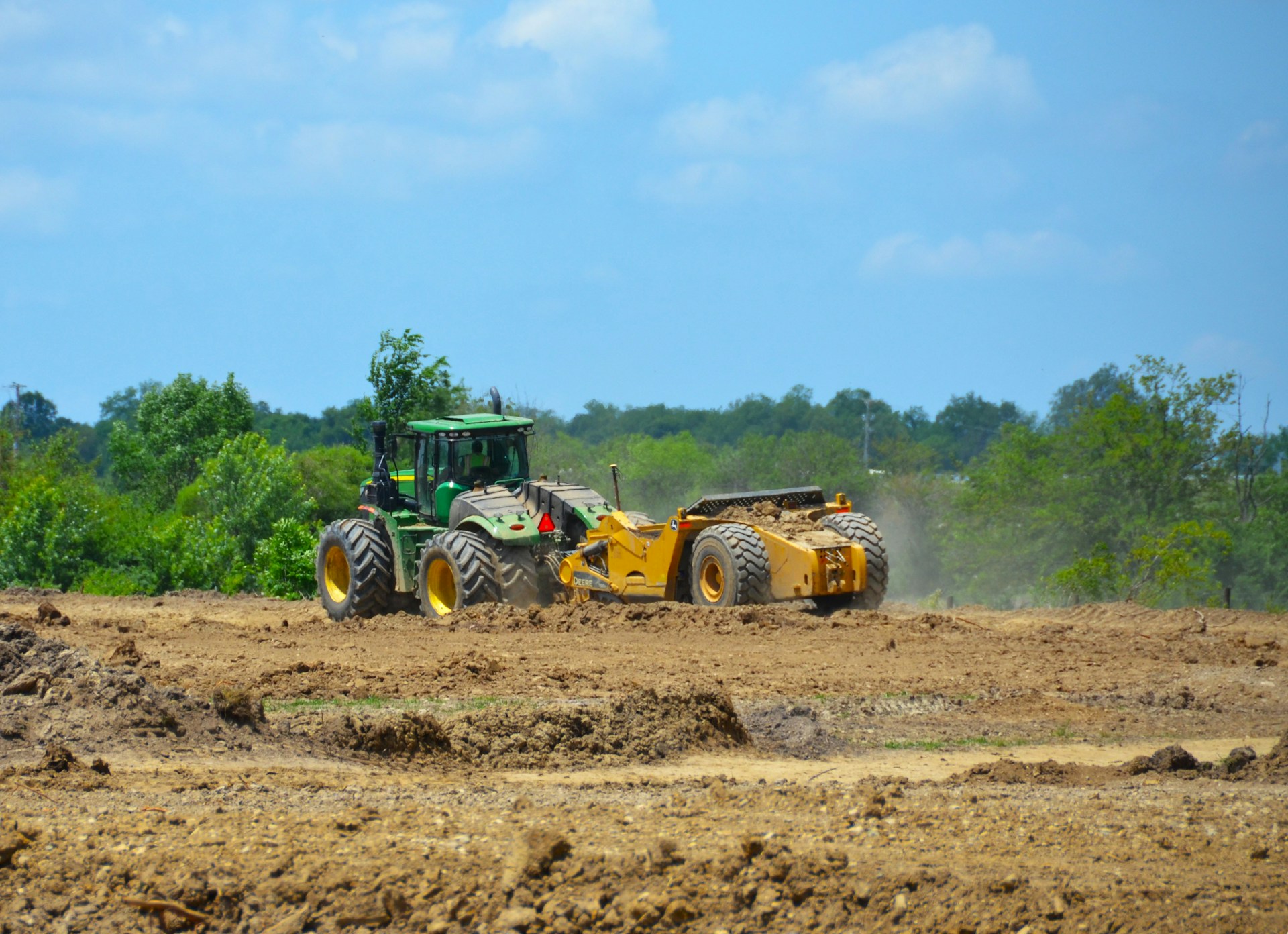 a tractor is plowing a field of dirt