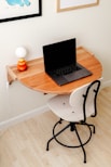 a laptop computer sitting on top of a wooden desk