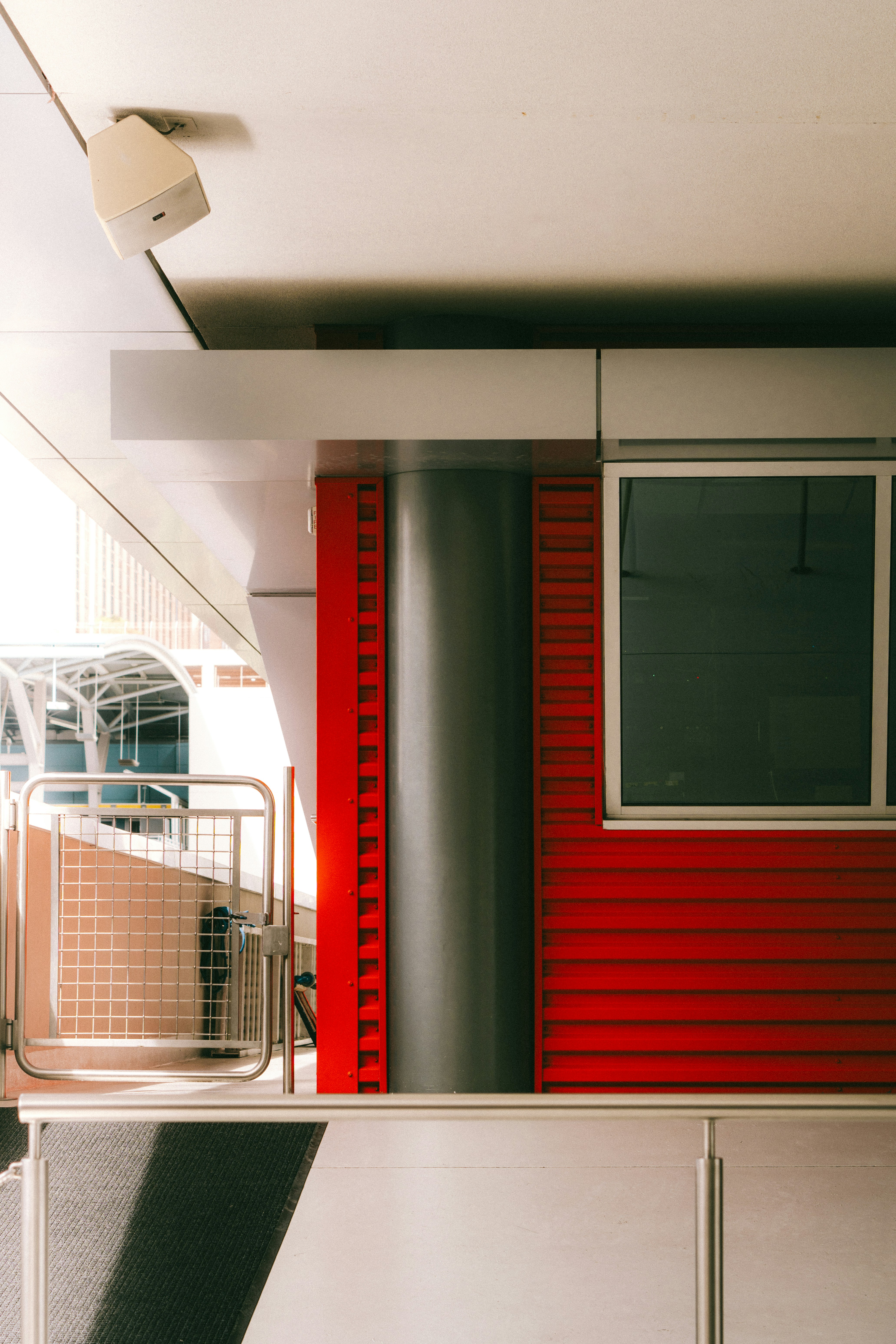 a room with a red wall and a metal railing