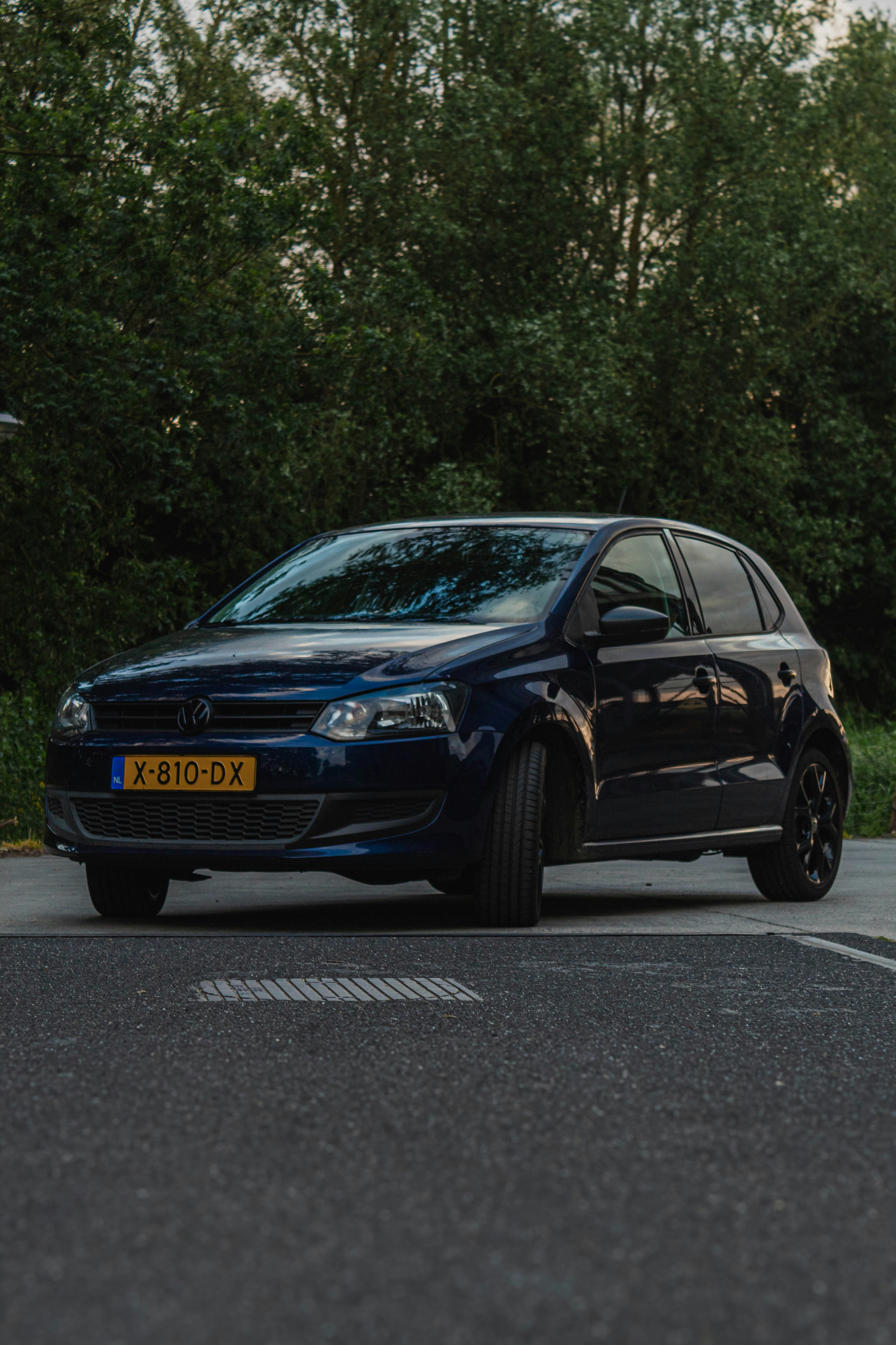 a blue car parked on the side of the road