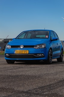 a blue car parked in a parking lot