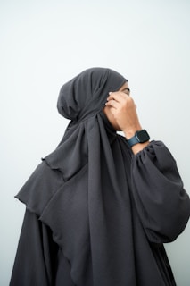 a woman in a black hijab covering her face