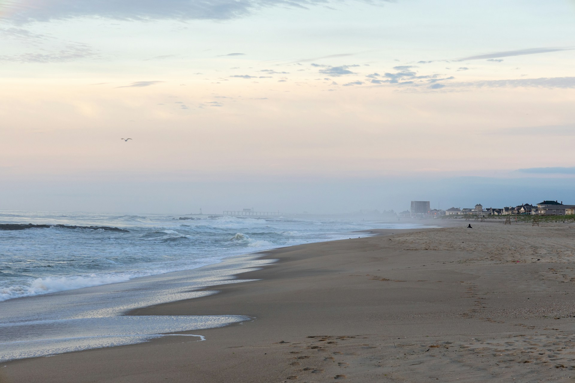 a sandy beach with waves coming in to shore