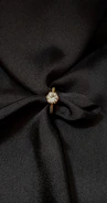 a close up of a black fabric with a ring on it