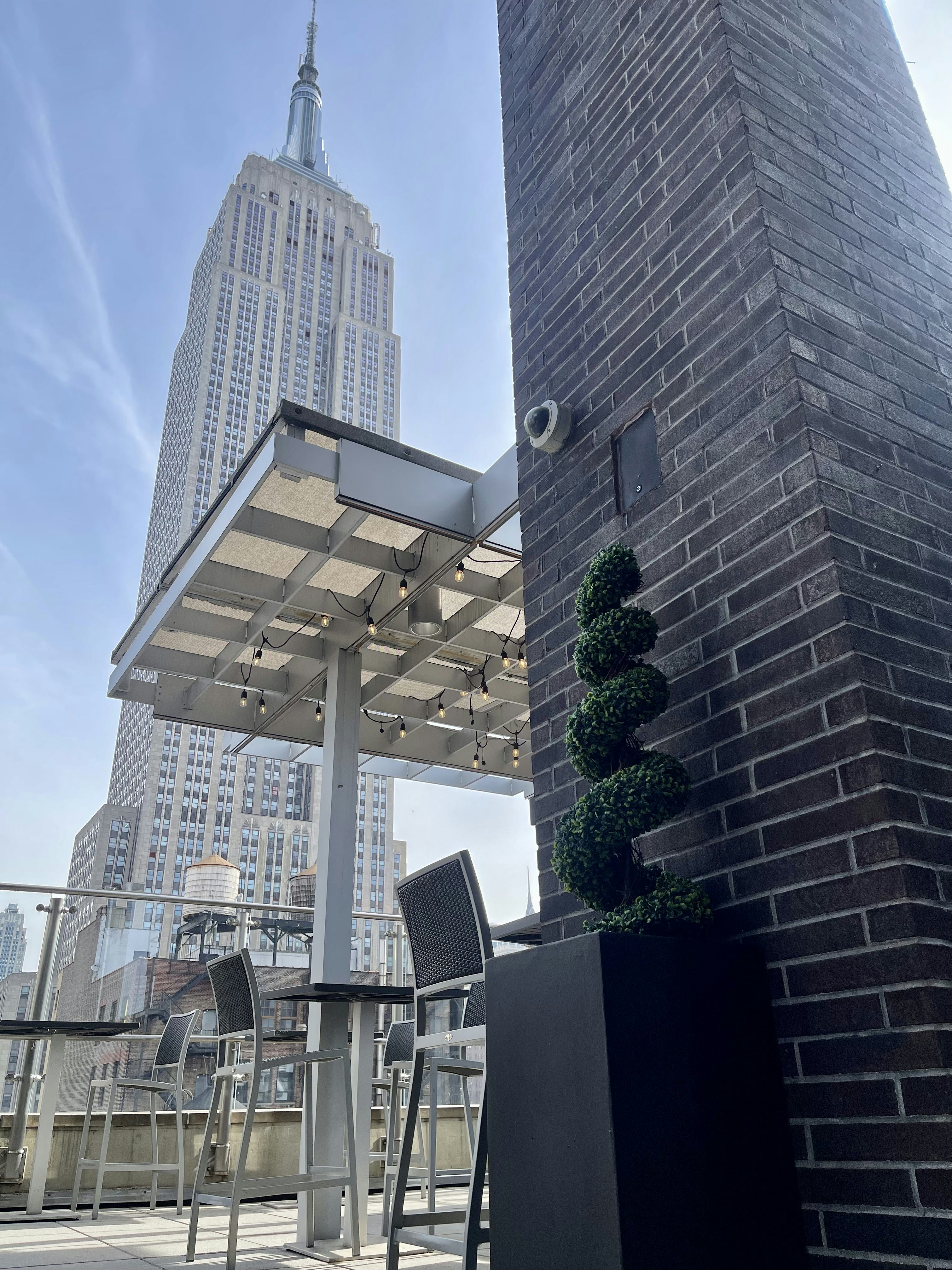 Rooftop bar in New York City with skyline views and diverse LGBTQ+ crowd enjoying cocktails