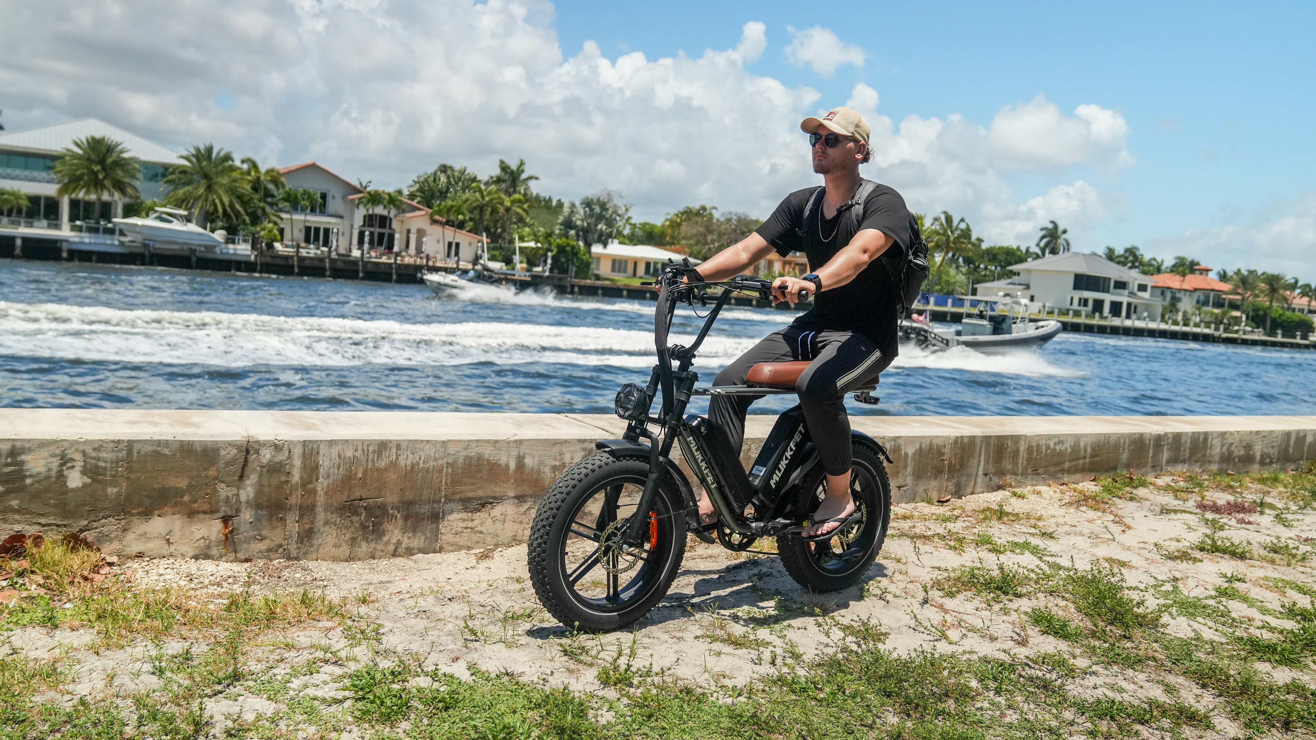 a man riding a bike near a body of water