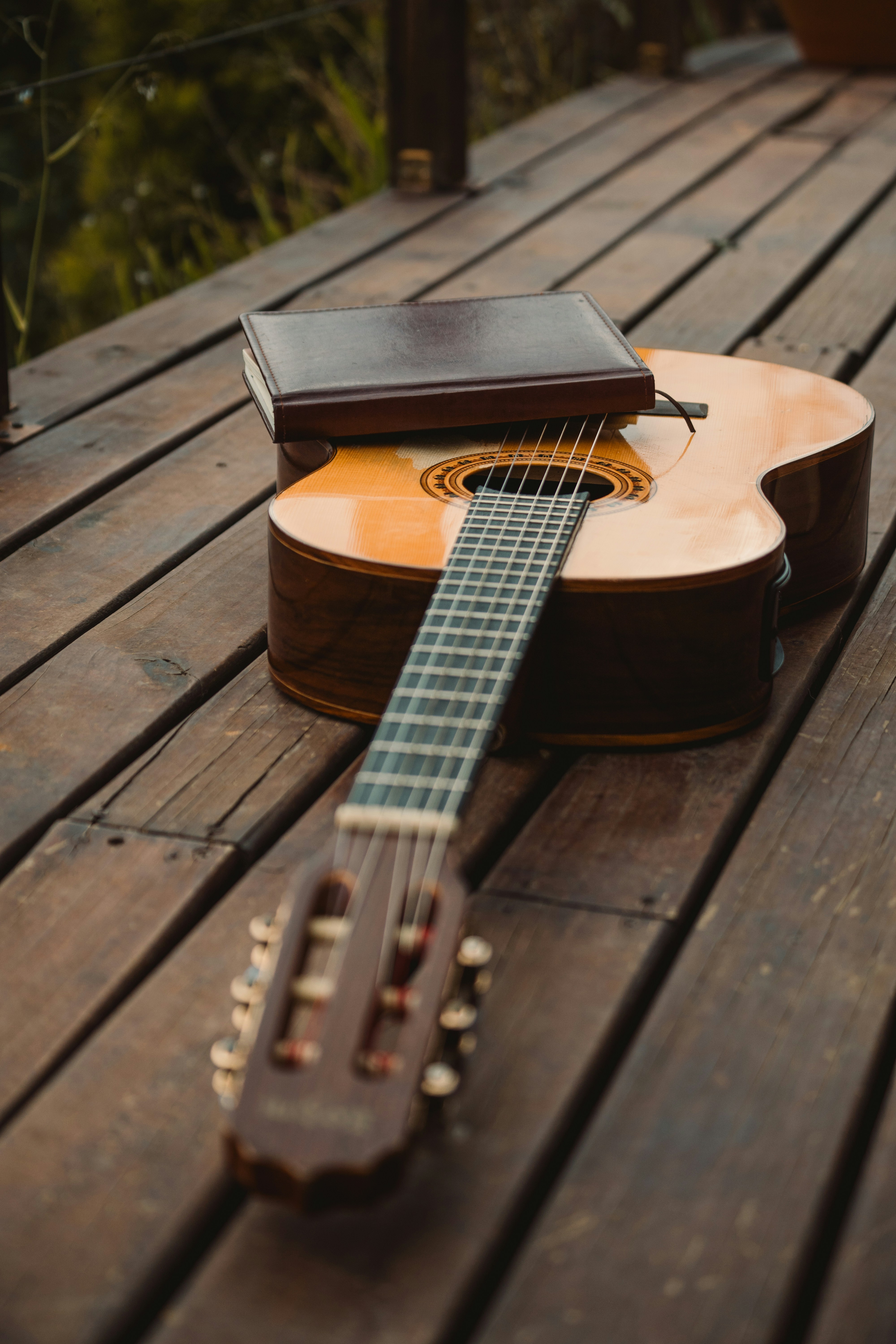 a guitar sitting on top of a wooden table