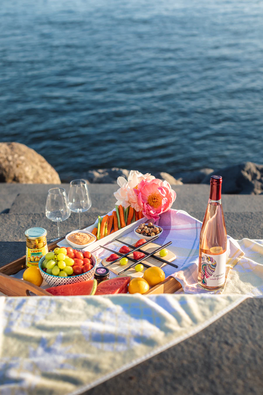 Beach picnic at Vlychada with food and wine on the sand in Santorini