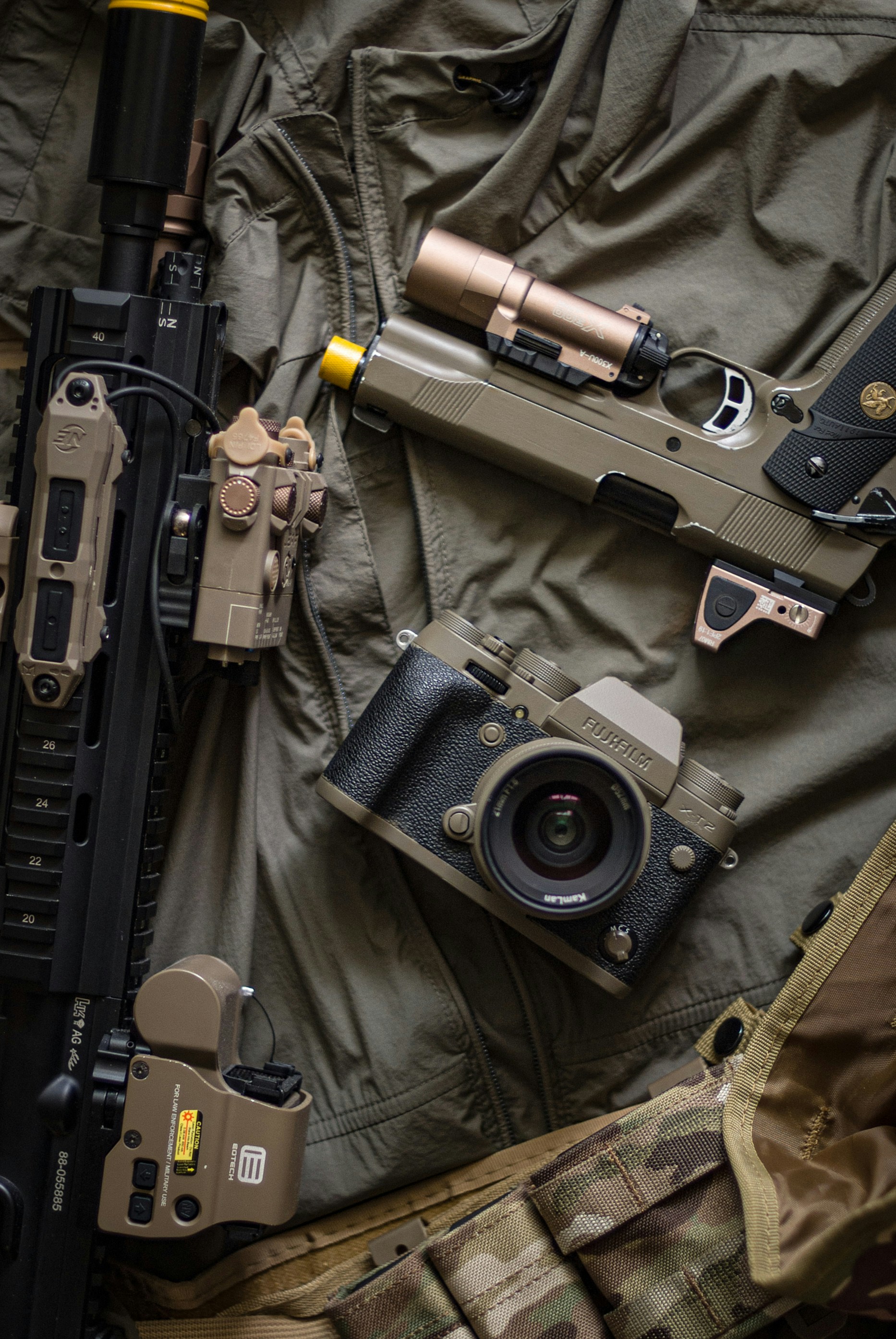 Military style combat shirt in multicam pattern folded on dark surface, tactical apparel