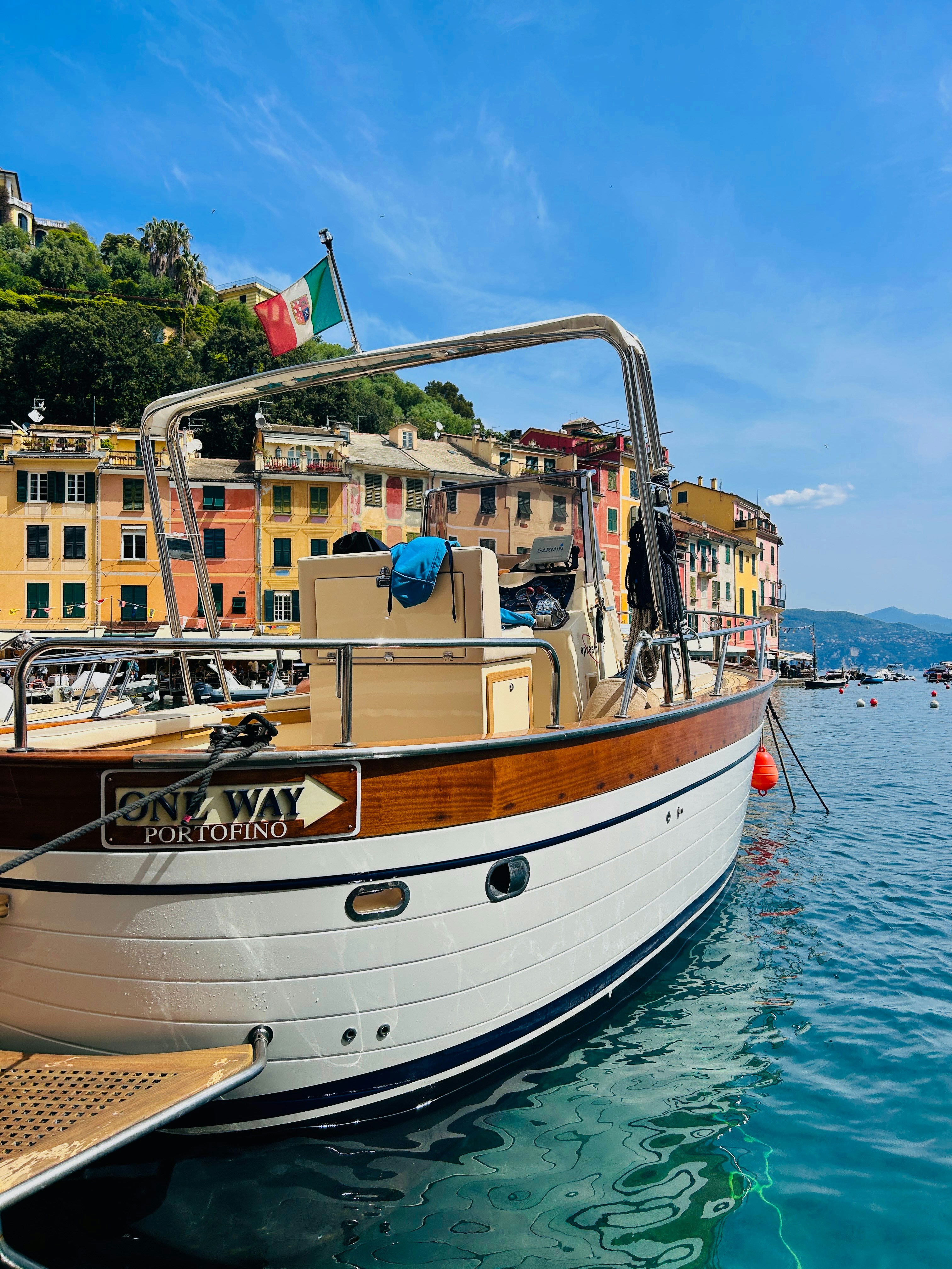 a boat docked in a harbor with buildings in the background